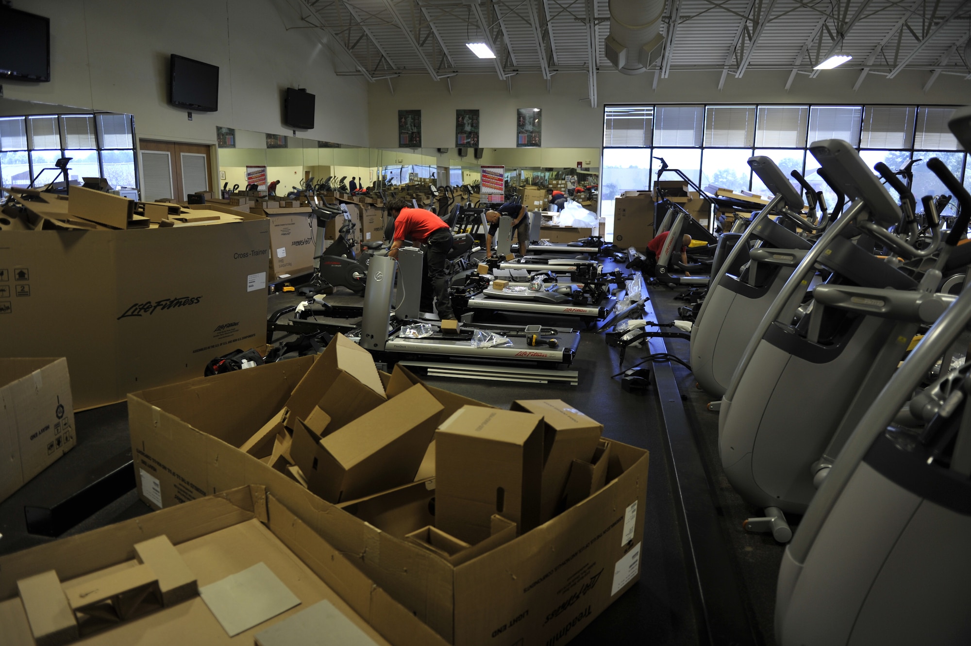 Life Fitness employees unpack and install new fitness equipment Oct. 25, at the Fitness Center at Little Rock Air Force Base, Ark. With more than 400 pieces of equipment being installed, the Fitness Center will be able to provide a better service for the approximate 1,300 team Little Rock members they serve daily. (U.S. Air Force photo by Senior Airman Caleb Pierce)

