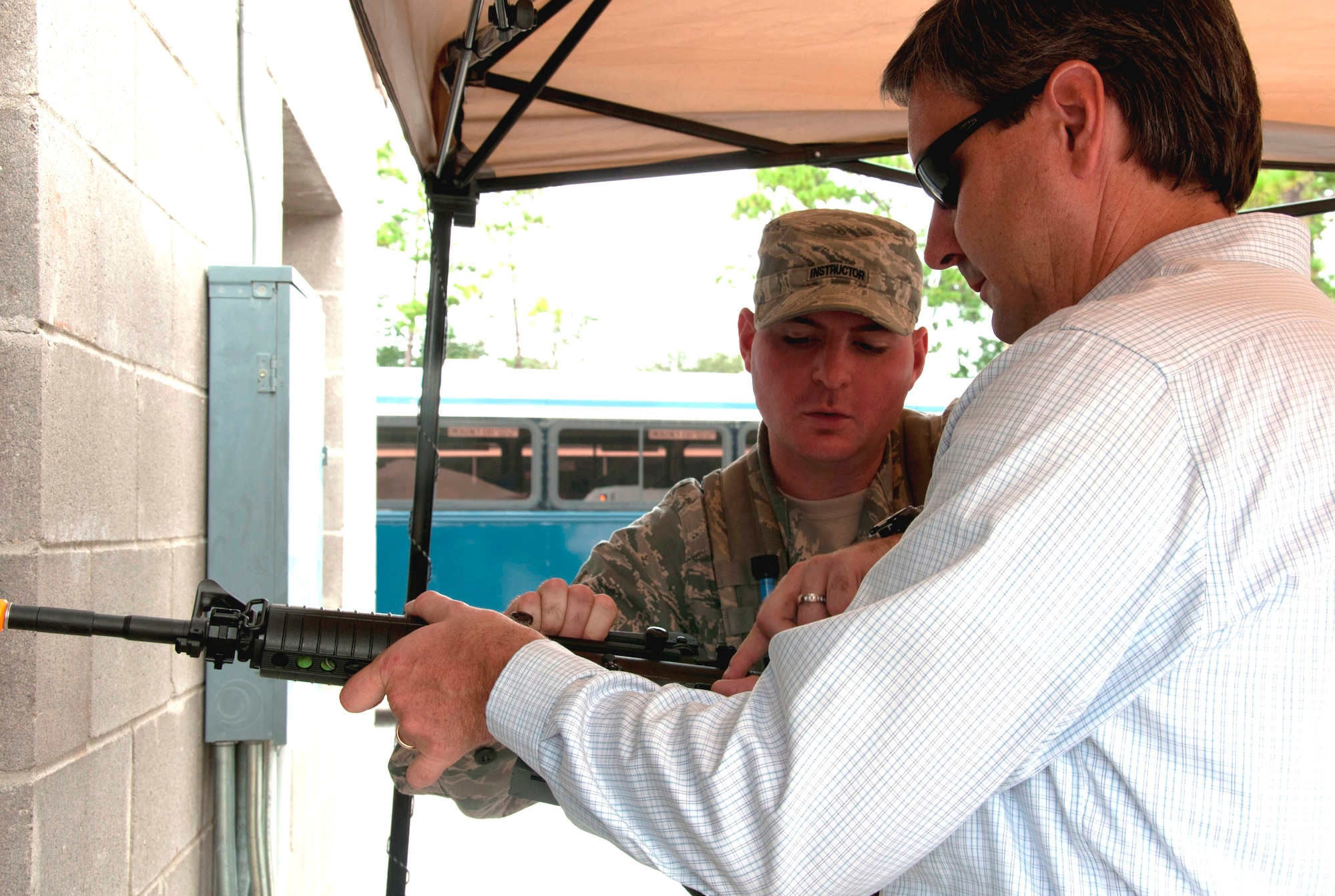 AETC Commander's Group member Danny Cremeens gets guidance from an instructor with the 96th Ground Combat Training Squadron at Eglin Air Force Base, Fla., Sept. 28, 2011. Cremeens represented Sheppard Air Force Base for three years and is now an emeritus member of the group. The AETC Commander's Group visited both Eglin AFB and Hurlburt Field during their conference in late September. (U.S. Air Force photo/Collen McGee)