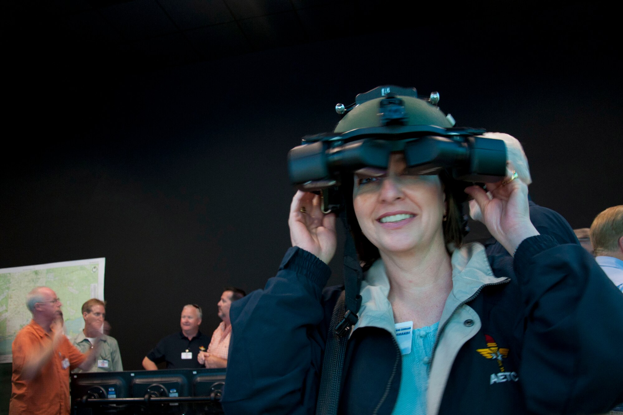 AETC Commander's Group member Linda Beltchev tries on a night vision goggles helmet used by special operations combat controllers Sept. 29, 2011, while visiting Air Force Special Operations Command at Hurlburt Field, Fla. Beltchev represents Sheppard Air Force Base, and has been a member for two years. The AETC Commander's Group visited both Eglin AFB and Hurlburt Field during their conference in late September. (U.S. Air Force photo/Collen McGee)