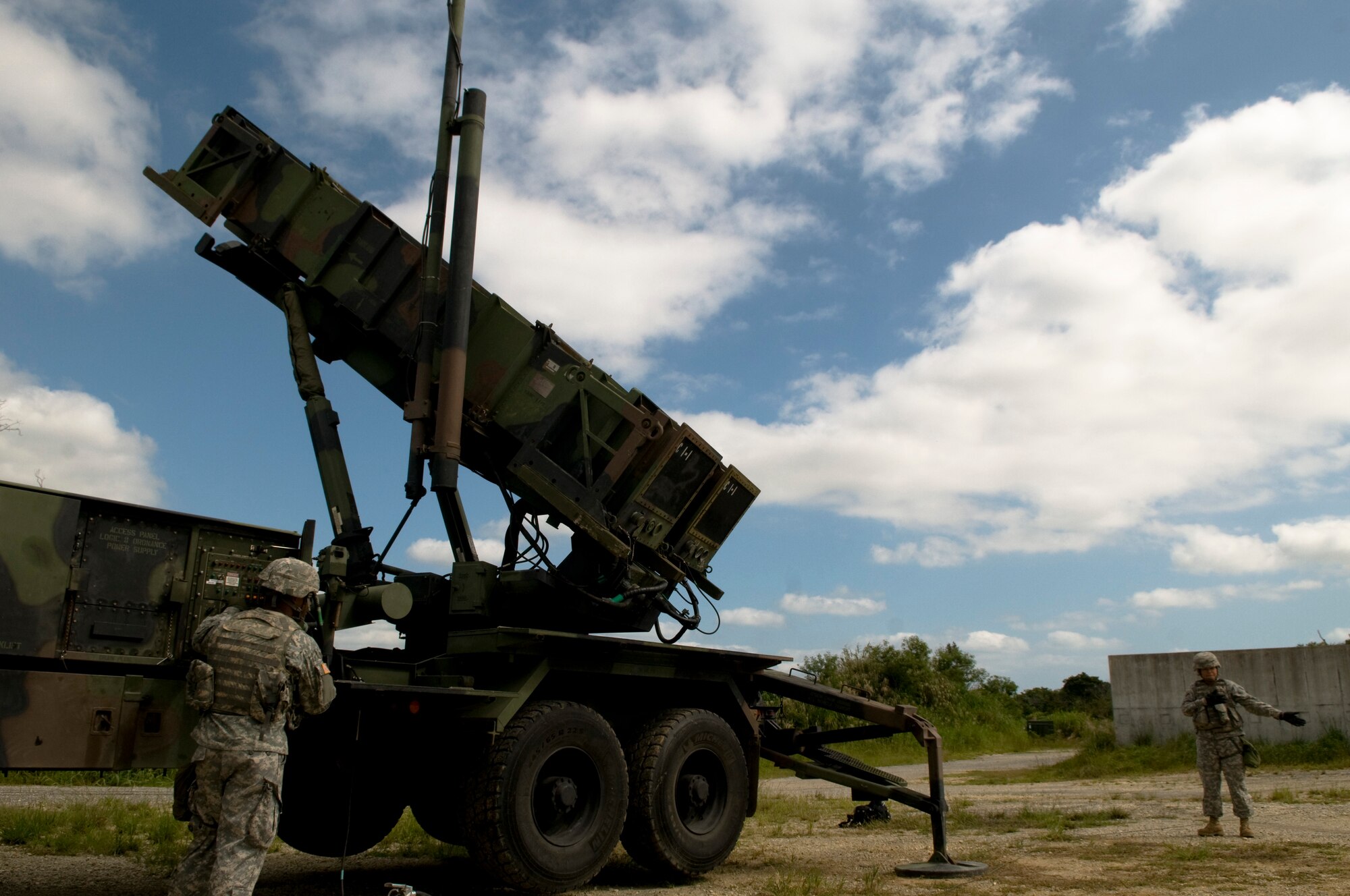 U.S. Army Privates 1st Class Dean Werner and Danica Sasakura, 1-1 Air Defense Artillery, Charley Battery Patriot Missile operators, perform pre-launch checks on a Patriot Missile launcher as part of a field training exercise on Kadena Air Base, Japan, Oct. 26. The unit stationed on Kadena conducts training two to three times a year to ensure the safety of Japan and the other U.S. forces stationed here. (U.S. Air Force photo/Airman 1st Class Maeson L. Elleman/released)