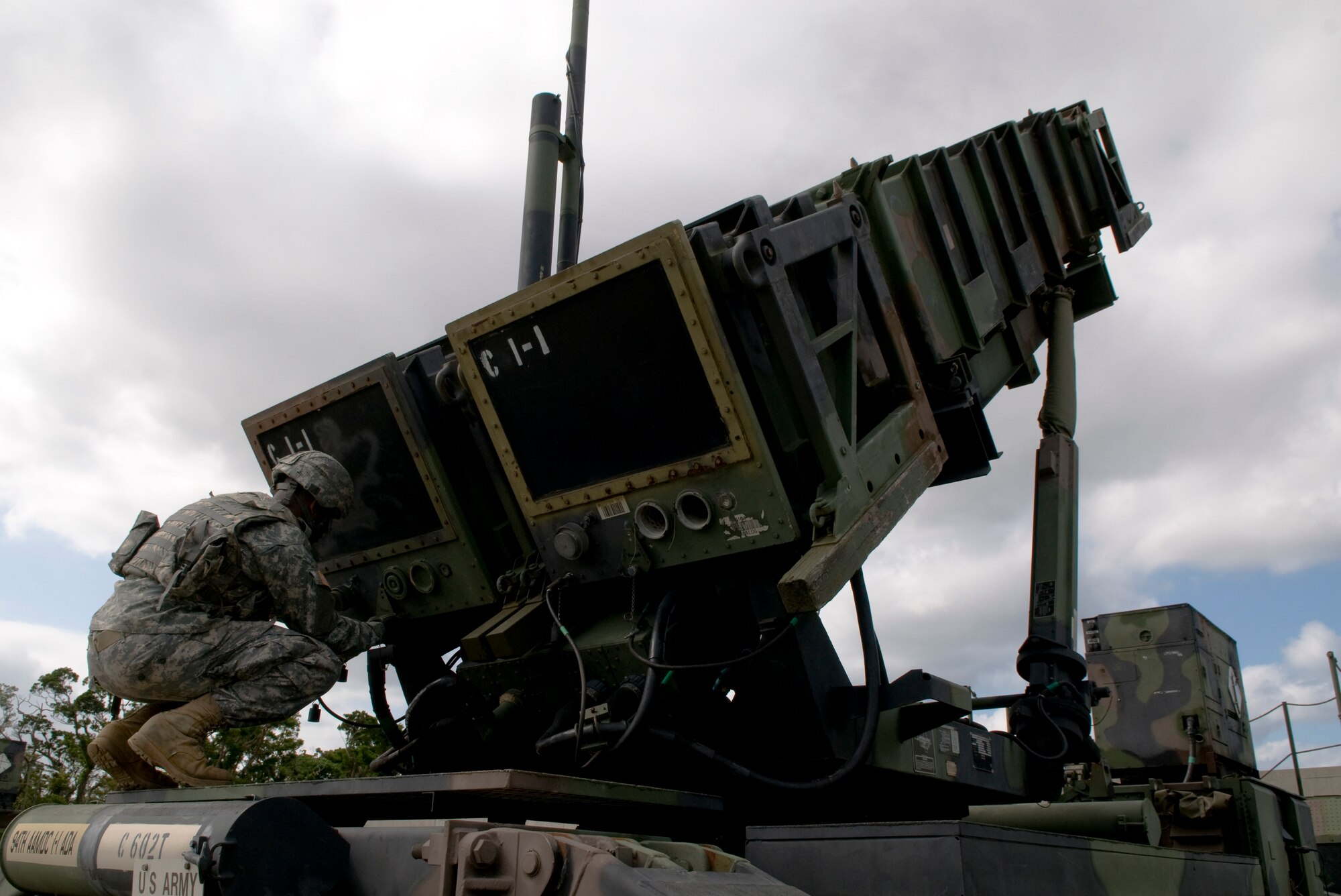 U.S. Army Private 1st Class Dean Werner, 1-1 Air Defense Artillery, Charley Battery Patriot Missile operator, simulates unlocking the launcher caps during a field training exercise on Kadena Air Base, Japan, Oct. 26. Kadena Air Base hosts the largest combat wing in the Pacific and includes U.S. Air Force, Army, Navy and Marine Corps assets. (U.S. Air Force photo/Airman 1st Class Maeson L. Elleman/released)