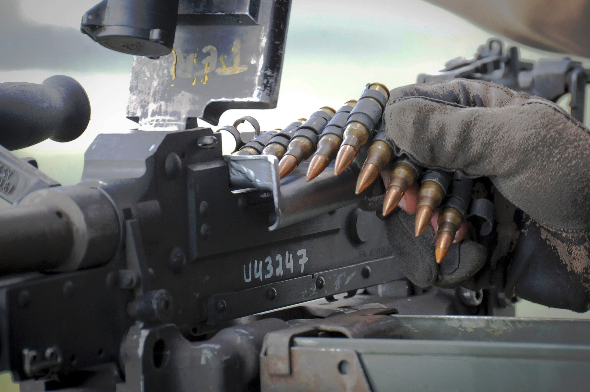 Lance Cpl. Ryan Jackson, a crew chief with the Marine Light Attack Helicopter Squadron 773, loads a belt of 7.62mm rounds into an M240 machine gun attached to a UH-1N Iroquois helicopter during a Joint Tactical Recovery of Aircraft and Personnel exercise held Oct. 15 here. The Joint TRAP exercise tested the Reservists’ ability to recover downed-aircrew members behind enemy lines and return them to a safe location. Jackson provided cover fire so the downed Marine aircrew members could be rescued. Jackson is a Cleveland, Texas native. (U.S. Air Force photo by Airman 1st Class Dennis L. Sloan/Released) 