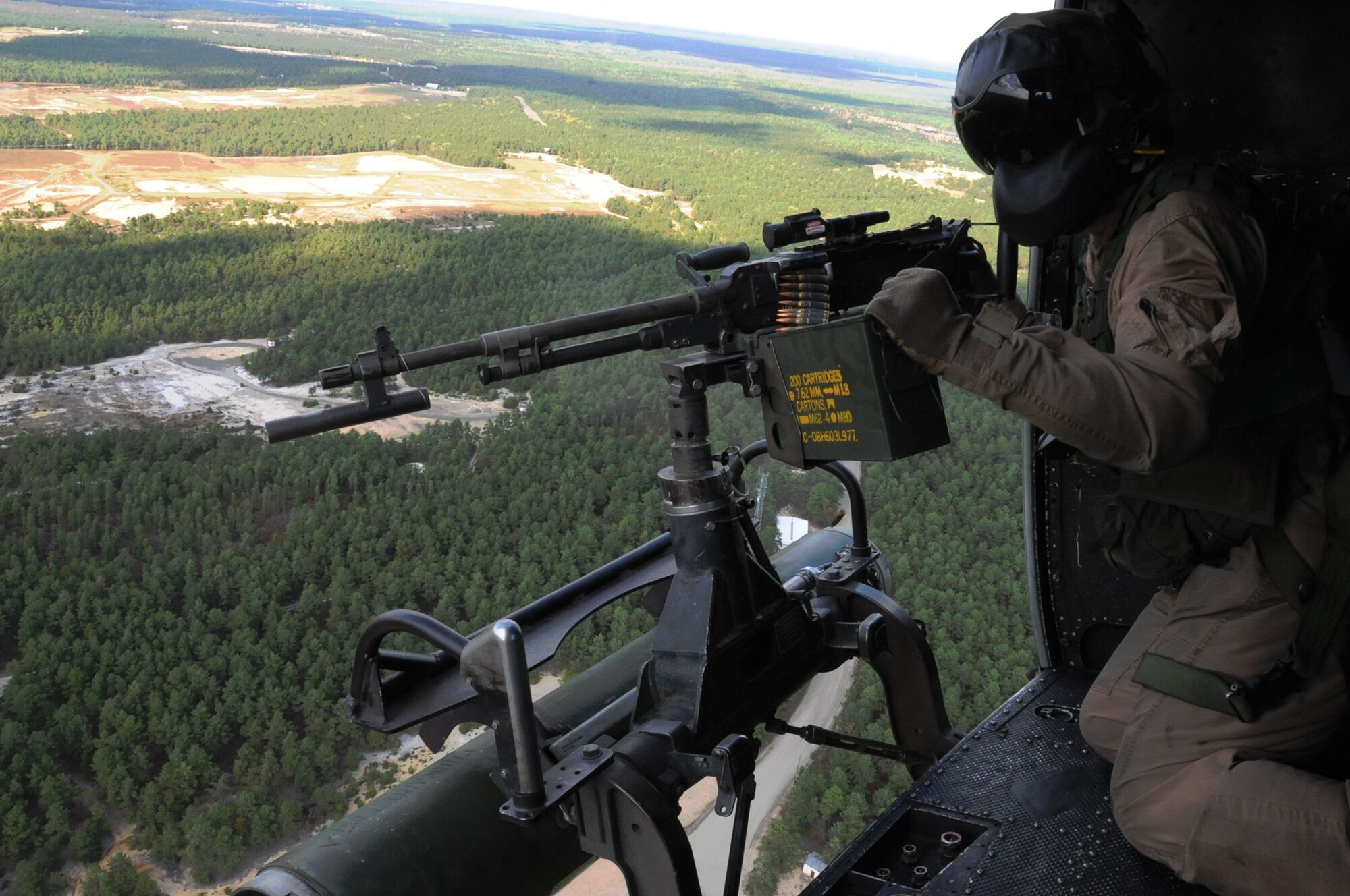 Lance Cpl. Ryan Jackson, a crew chief with the Marine Light Attack Helicopter Squadron 773, fires a M240 machine gun from a UH-1N Iroquois helicopter Oct. 15 here during a Joint Tactical Recovery of Aircraft and Personnel exercise. The Joint TRAP exercise tested the reservists’ ability to recover downed aircrew from behind enemy lines. Marines with the Marine Aircraft Group 49 organize, train and equip combat-ready squadrons to augment and reinforce the active Marine forces in time of war, national emergency or contingency operations. Jackson is a Cleveland, Texas native. (U.S. Air Force photo by Airman 1st Class Dennis L. Sloan/Released)