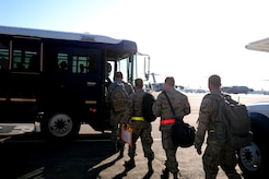 Joint Base Charleston Airmen board a bus to take them to their aircraft during an operational readiness exercise Oct. 25, 2011. The ORE is in preparation for the command's upcoming operational readiness inspection which evaluates Airmen's mission readiness in preparation for real world deployments. (U.S. Air Force photo/ Staff Sgt. Nicole Mickle)