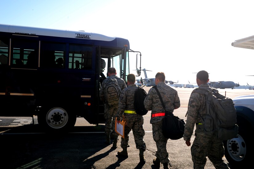 Joint Base Charleston Airmen board a bus to take them to their aircraft during an Operational Readiness Exercise at JB Charleston, Oct. 25. The ORE is in preparation for the command's upcoming Operational Readiness Inspection which evaluates Airmen's mission readiness in preparation for real world deployments.  (U.S. Air Force photo/ Staff Sgt. Nicole Mickle)  