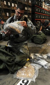 Staff Sgt. Jacob Stern looks through his B-bag to ensure he has everything he needs  as he prepares to deploy during the Operation Readiness Exercise at Joint Base Charleston, Oct. 25. The B-bag contains an Airmen's cold weather gear. The ORE is in preparation for the command's upcoming Operational Readiness Inspection which evaluates Airmen's mission readiness in preparation for real world deployments. Stern is an Explosive Ordnance Disposal Apprentice with the 315th Civil Engineer Squadron. (U.S. Air Force photo/Airman 1st Class Ashlee Galloway)