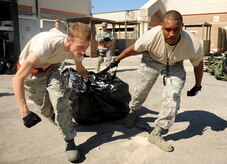 Senior Airman Chris Lindsay and Staff Sgt. Stephen Kohn pull a tent into place during an operational readiness exercise in Gulfport, Miss. on Oct. 24, 2011. The ORE is in preparation for the command's upcoming operational readiness inspection which evaluates Airmen's mission readiness in preparation for real world deployments. Lindsay and Kohn are both from the 628th Security Forces Squadron. (U.S. Air Force illustration/Staff Sgt. Chad Trujillo)