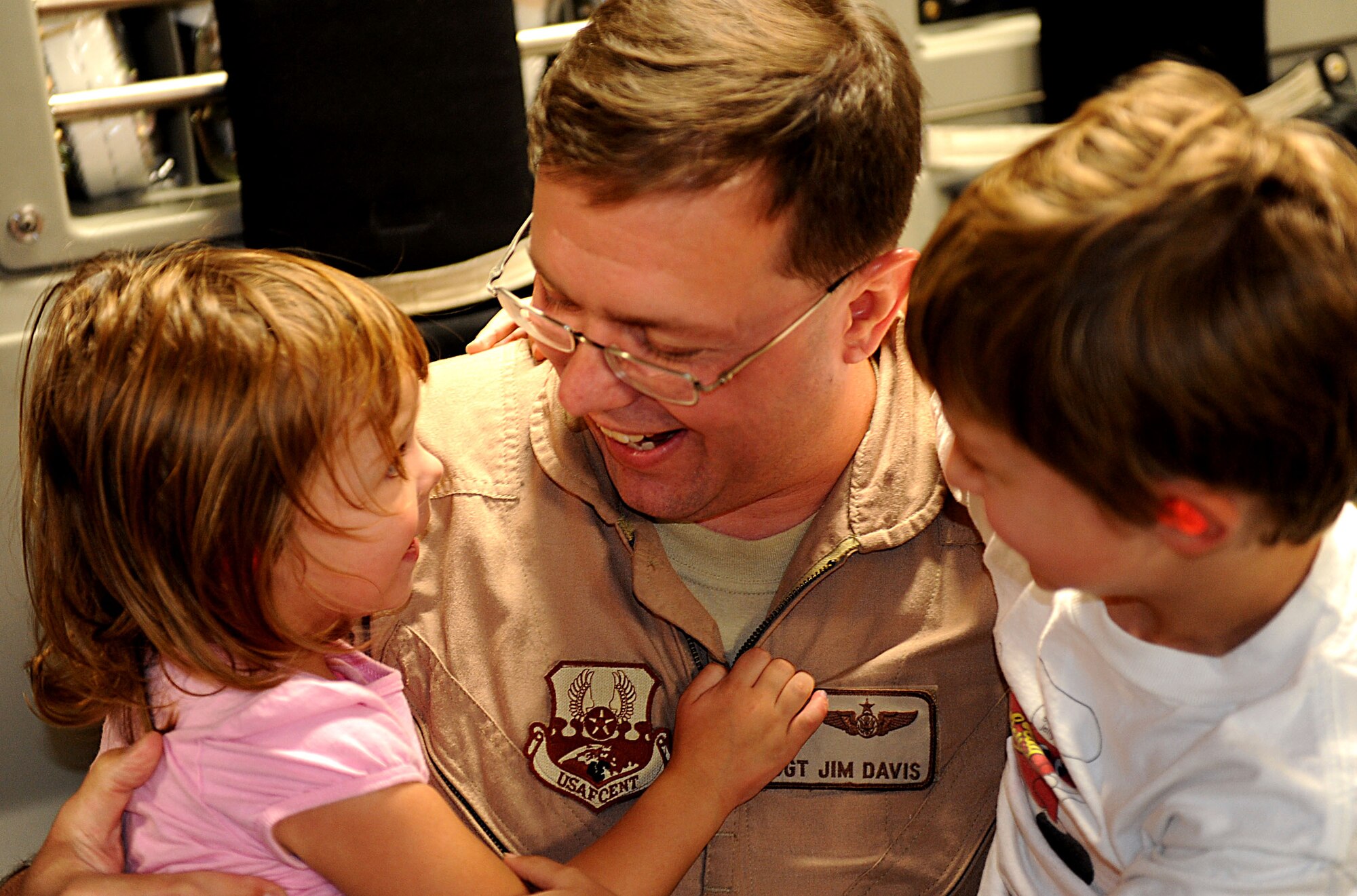 U.S. Air Force Tech. Sgt. James Davis, 33rd Rescue Squadron flight engineer, greets his children on Kadena Air Base, Japan, Oct. 26. Davis is a flight engineer from the 33rd Rescue Squadron returning home to Kadena from Travis Air Force Base, Calif. after spending several months in rehabilitation for a gunshot wound he acquired while serving in Afghanistan this spring. (U.S. Air Force photo/Airman 1st Class Brooke P. Beers/Released)