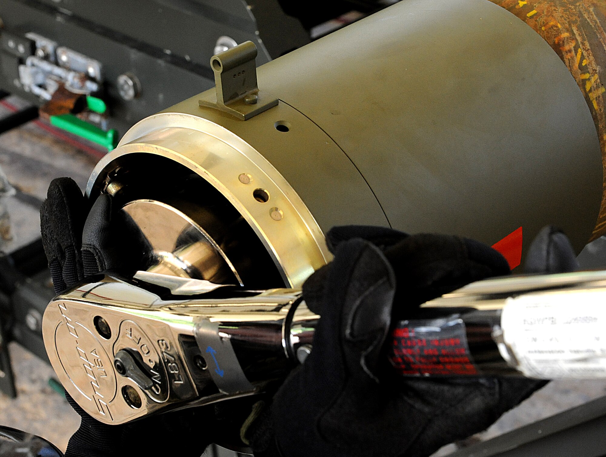 U.S. Air Force Airman 1st Class Chad Lambeth, 18th Munitions Squadron, crew member, tightens the front of the bomb for safe travel during local operational readiness exercise Beverly 12-1, on Kadena Air Base, Japan, Oct. 26. MUNS Airman support Kadena's two F-15 fighter squadrons, the 44th and 67th, as well as the 33rd Rescue Squadron and the 353rd Special Operations Group. (U.S. Air Force photo/Airman 1st Class Justin Veazie/released)