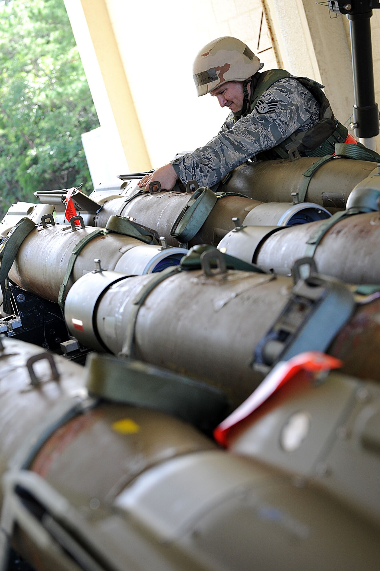 U.S. Air Force Staff Sgt. Matt Owens, 18th Munitions Squadron equipment maintenance supervisor, checks to make sure bombs are secured to a trailer during local operational readiness exercise Beverly High 12-1 on Kadena Air Base, Japan, Oct. 26. During LOREs, the MUNS Airmen practice building bombs in large quantities, only to take them apart and rebuild them again.  (U.S. Air Force photo/ Airman 1st Class Brooke P. Beers/released) 