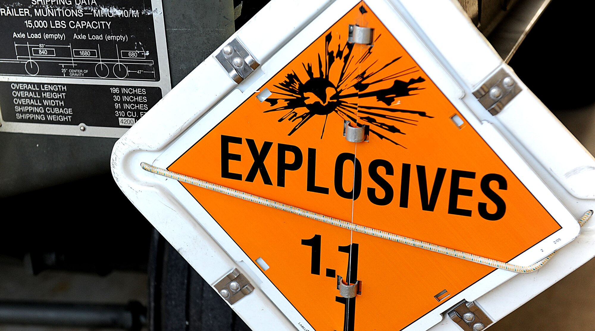 An explosives sign on a 18th Munitions Squadron trailer warns people driving too closely to keep their distance. During LOREs, the MUNS Airmen practice building bombs in large quantities, only to take them apart and rebuild them again.  (U.S. Air Force photo/ Airman 1st Class Brooke P. Beers/released)