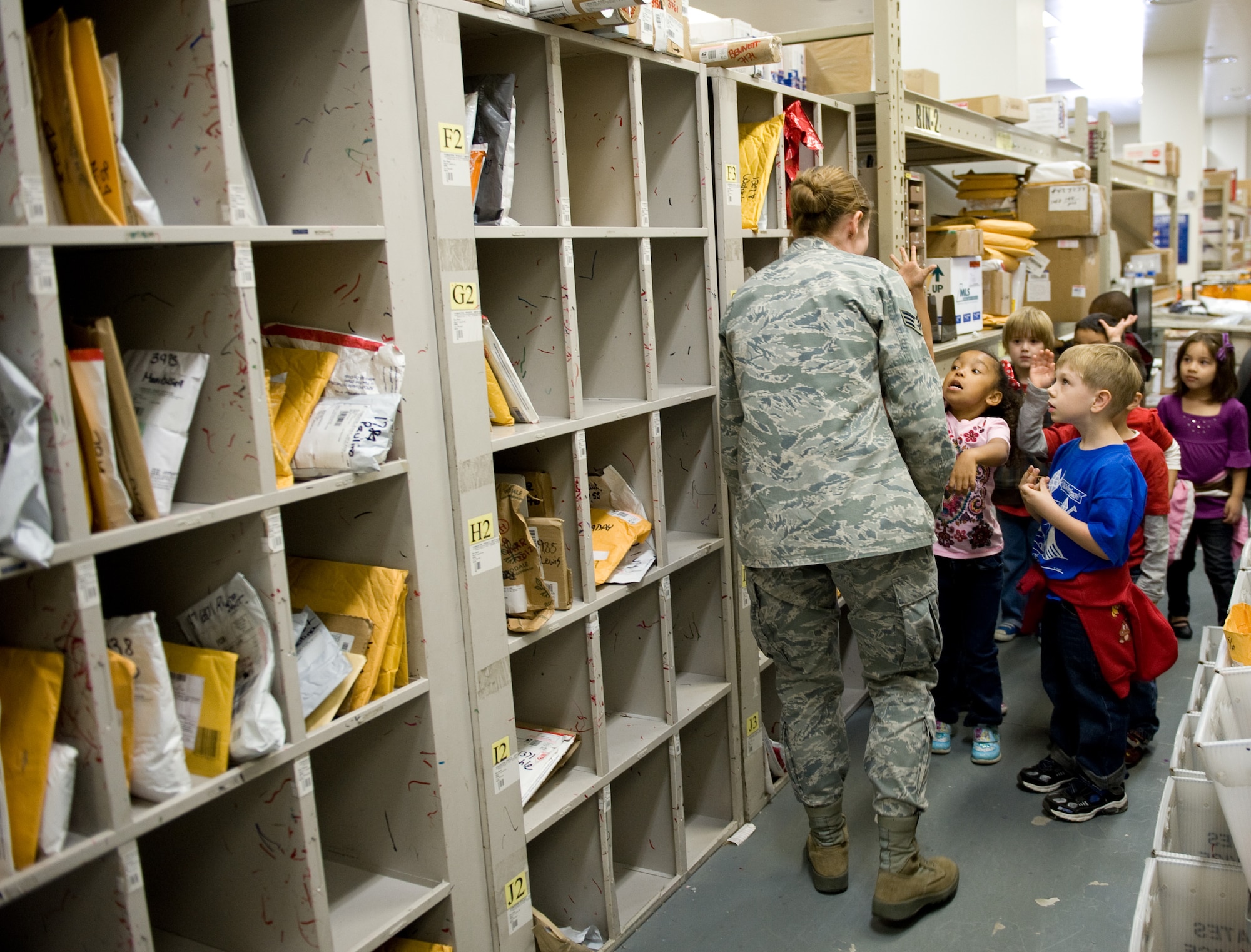 YOKOTA AIR BASE, Japan -- Senior Airman Erica Heal, 374th Communications Squadron military postal clerk, answers students' questions during a postal visit at Yokota Air Base, Japan, Oct. 26, 2011. The post office receives two or three trucks of mail each day. (U.S. Air Force photo/Airman 1st Class Krystal M. Garrett) 