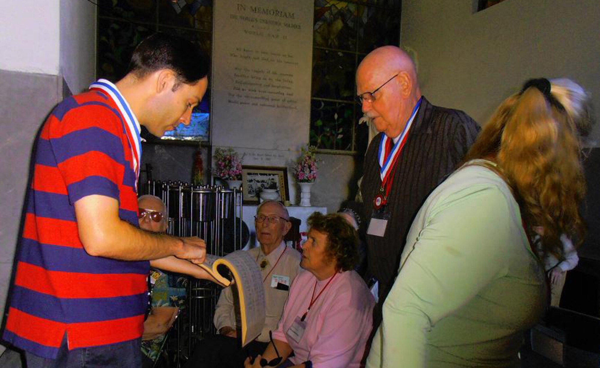 KYOTO, Japan -- Former U.S. prisoners of war view a book at the Ryozen Kannon temple, Kyoto, Japan, Oct. 20, 2011.  The book was one of many within the temple containing the names of the deceased from each country or region from World War II. (Courtesy photo)