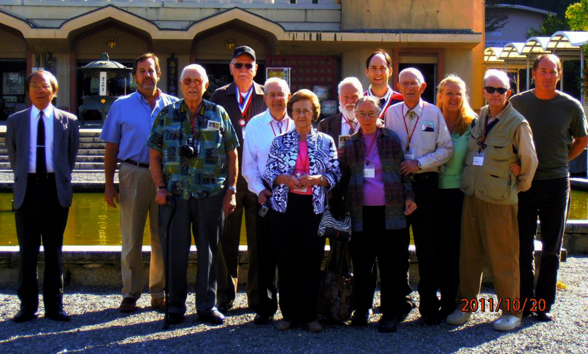 KYOTO, Japan -- Toru Fukubayashi (left) stands with former U.S. prisoners of war and their families outside the Ryozen Kannon temple in Kyoto, Japan, Oct. 20, 2011. The POWs were invited to Japan by the Ministry of Foreign Affairs to further promote the relationship between Japan and the U.S. by mending the scars of World War II. (Courtesy photo)