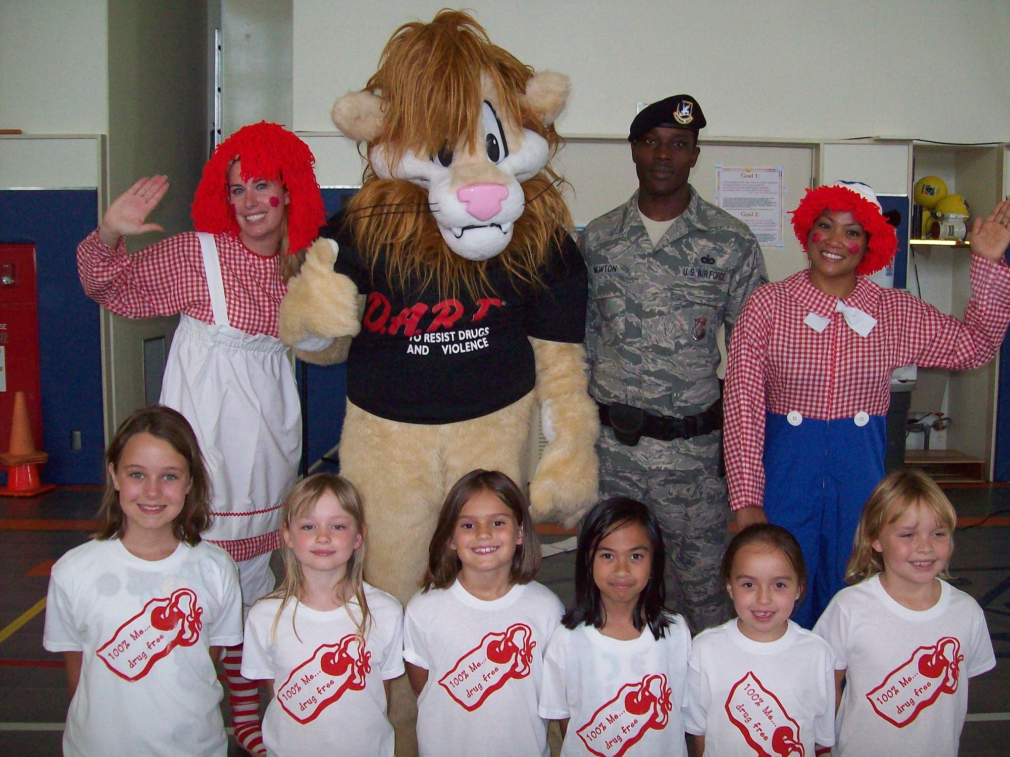 Trisha Adami as Raggedy Ann; Daren the D.A.R.E. Lion as himself; Tech. Sgt. Cedric Newton, 18th Security Forces Squadron flight chief; and Erna Waller as Raggedy Andy pose with Ella Adams, Laura McCallion, Laci Webb, Kathryn Codiamat, Alexis Orr and Ellie Dolan, Stearley Heights Elementary School students, during a Drug Abuse Resistance Education presentation at SHES on Kadena Air Base, Japan, Oct. 20. After leading the audience in reciting the Drug Free Pledge, Officer-Be-Helpful inducted 93 SHES kindergarteners as citizens into Daren the Lion’s Drug-Free Community. (Courtesy photo)