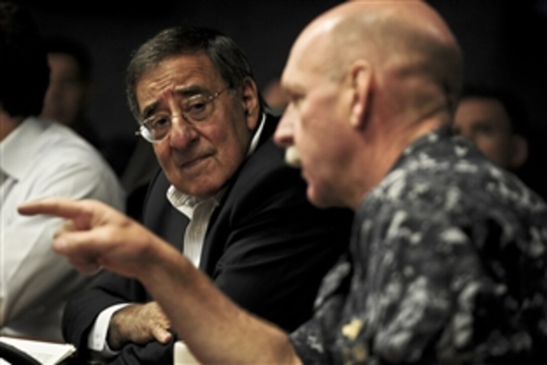 U.S. Navy Vice Adm. Scott H. Swift, commander of 7th Fleet, right, briefs Defense Secretary Leon E. Panetta on Operation Tomodachi, the Navy's humanitarian assistance and disaster relief effort in response to the earthquake that struck Japan on March 11, 2011, aboard the USS Blue Ridge on Yokosuka Naval Base, Japan, Oct. 26, 2011. 