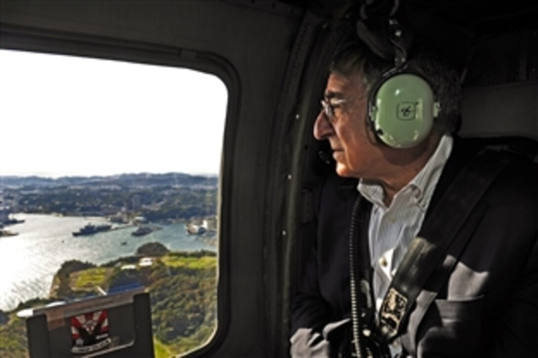 U.S. Defense Secretary Leon E. Panetta travels aboard an Army HH-60 Black Hawk helicopter on his way to visit sailors stationed aboard the USS Blue Ridge on Yokosuka Naval Base, Japan, Oct. 26, 2011. 
