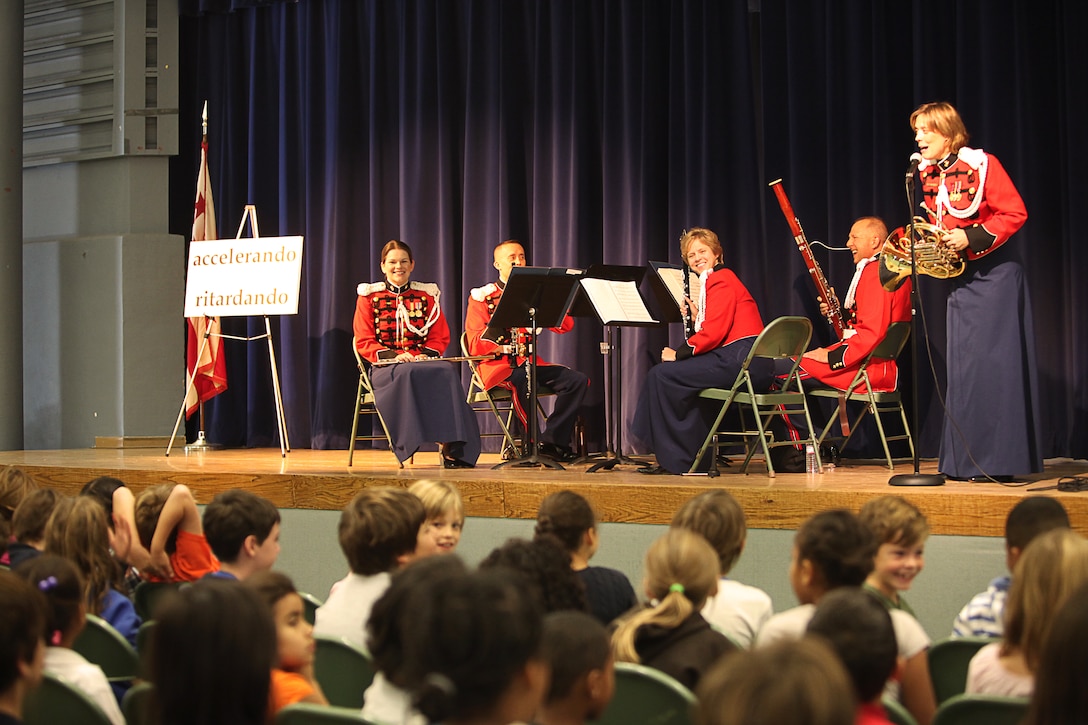 Master Sgt. Amy Horn, a French horn player with the U.S. Marine Band, explains to students what instrument she plays during a Music in the Schools presentation at Lafayette Elementary School here Oct. 26. For approximately five decades, the MITS program and “The President’s Own” musicians have brought education and entertainment to children through small instrumental group performances. The U.S Marine Band conducted more than 30 performances in D.C. area primary schools bringing music to approximately 5,000 students throughout the month of October.