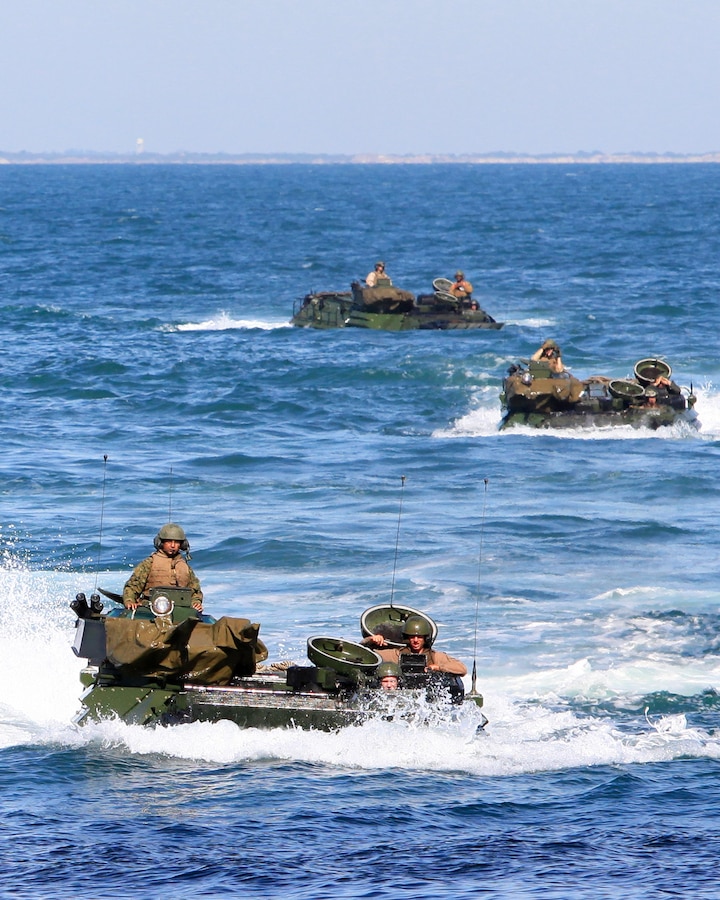 USS IWO JIMA (LHD 7) – Assault Amphibian vehicle (AAV) crewmen from 2nd Assault Amphibian Vehicle platoon, Battalion Landing Team 1st Battalion, 2nd Marine Regiment, 24th Marine Expeditionary Unit  make their way to the well deck of the amphibious assault ship USS Iwo Jima, from the USS New York Oct. 26, 2011. The AAV’s practiced loading and off loading from the Iwo Jima as part of the Amphibious Squadron 8 (PHIBRON 8)/ MEU Integration Exercise, known as PMINT. PMINT will take place Oct. 24 to Nov. 3 and is focused on building the Navy-Marine Team and establishing the working relationships and practices necessary to conduct operations from the sea. (Official USMC Photo by: Lance Cpl Michael J. Petersheim/ Released)