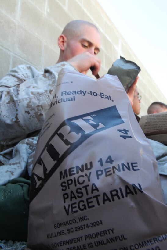 Cpl. Darrell Kincaid, a rifleman with Charlie Company, 1st Battalion, 2nd Marine Regiment, eats a vegetarian Meal Ready to Eat during the Motorized Raid Course Oct. 26, at Stone Bay's Home Station Lane Training complex here.  The course took place Oct. 24 to Nov. 4 to prepare the company to serve as the 24th Marine Expeditionary Unit's motorized raid force.  Kincaid, a native of Victor, W. Va., prides himself on being a vegetarian and still maintaining a high level of physical fitness. (USMC Photo by: Sgt. Richard Blumenstein/ Released)