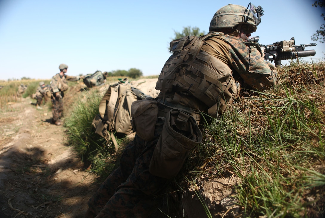 Marines with 2nd Platoon, Bravo Company, 1st Battalion, 6th Marine Regiment, take positions to support a group of Marines receiving enemy small-arms fire during Operation Eastern Storm. The Marines and sailors of Bravo Co. are participating in the operation to clear out insurgents in the area, making it safe for residents to return to the area once terrorized by insurgents and improvised explosive devices.