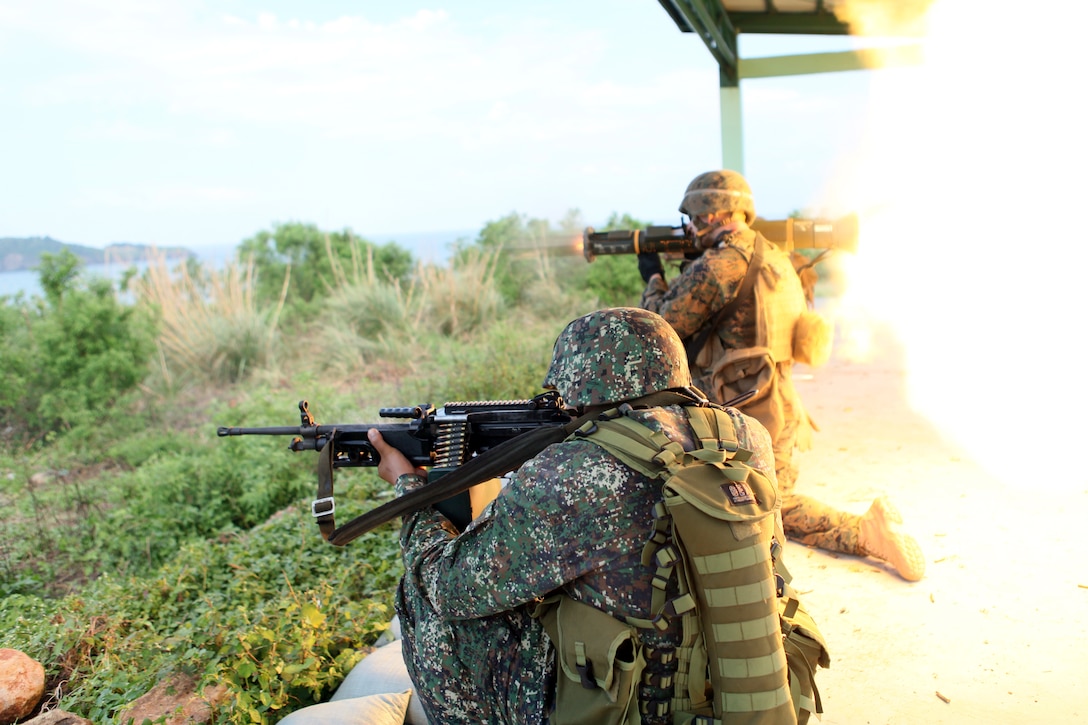 As a Philippine reconnaissance Marine provides security, a U.S. Marine of force reconnaissance platoon, 31st Marine Expeditionary Unit, fires an anti-tank rocket launcher during a movement to contact drill on a live-fire range here on Oct. 27, 2011, during the Amphibious Landing Exercise. PHIBLEX is a bilateral training event that is designed to improve interoperability between the two allied forces and increase the readiness of individual units. The 31st MEU is operating in support of III Marine Expeditionary Brigade for the exercise and remains the United States’ force in readiness in the Asia-Pacific region.