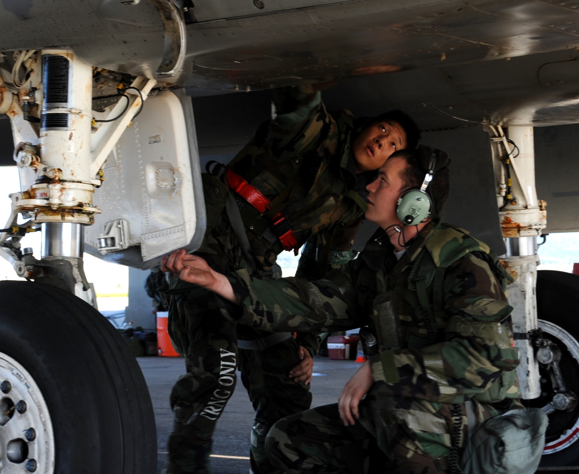 U.S. Air Force Airman 1st Class Ronald Chang and Senior Airman Kyle Goodrick, both 18th Aircraft Maintenance Squadron crew chiefs, prepare an F-15 Eagle for launch during local operational readiness exercise Beverly High 12-1 Oct. 28, on Kadena Air Base, Japan. Although crew chiefs and other maintenance personnel are generating sorties, they are still required to wear the appropriate protective gear during the LORE. (U.S. Air Force photo/Staff Sgt. Christopher Hummel/released)