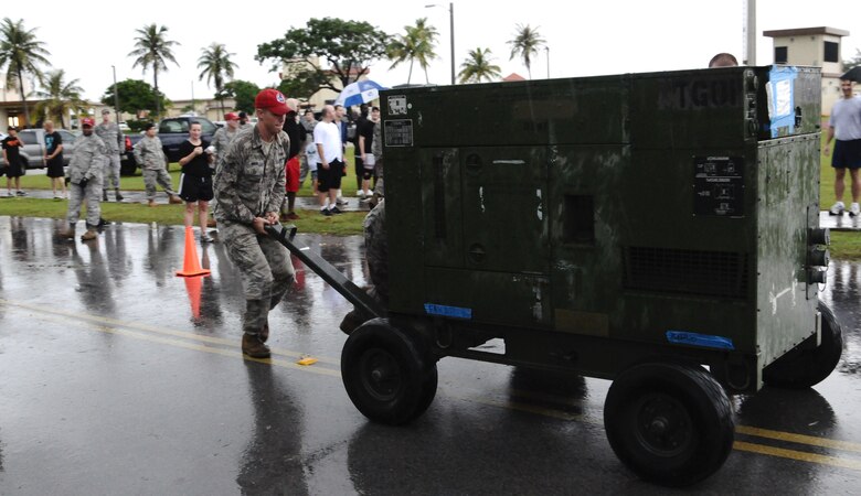 ANDERSEN AIR FORCE BASE, Guam— An Airman from Andersen’s 554th Red Horse Squadron pushes a generator during the 36th Contingency Response Group’s warrior challenge here, Oct. 21. Each squadron assigned to the 36 CRG competed against each other during the challenge. (U.S. Air Force photo by Senior Airman Benjamin Wiseman/Released)