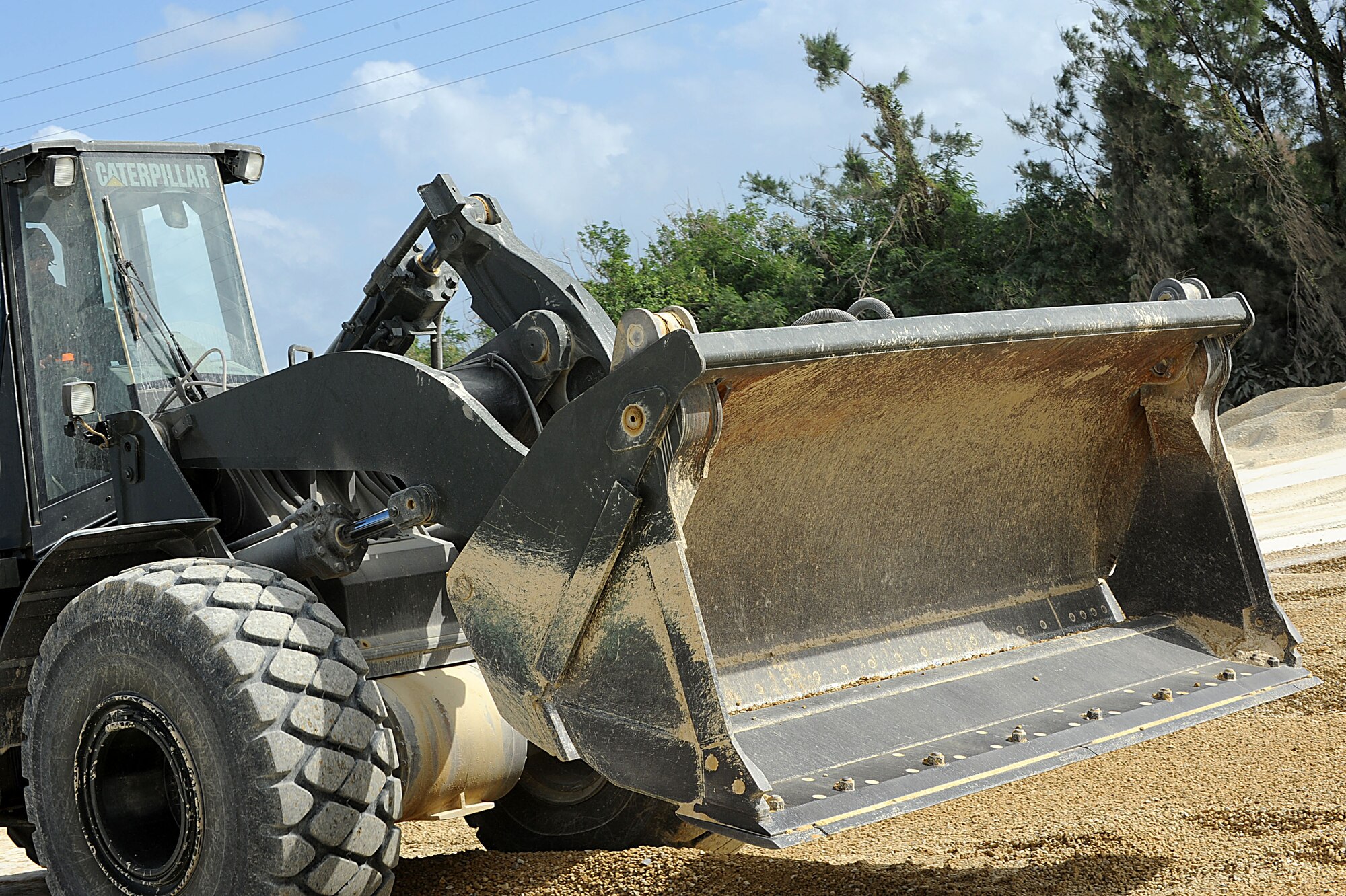 U.S. Air Force Staff Sgt. Bradly Schrage, 18th Civil Engineer Squadron pavement and equipment operator, operates a loader while training on Kadena Air Base, Japan, Oct. 27. The CES Airmen were training on airfield repair during local operational readiness exercise Beverly High 12-1. (U.S. Air Force photo/Airman 1st Class Brooke P. Beers/Released)