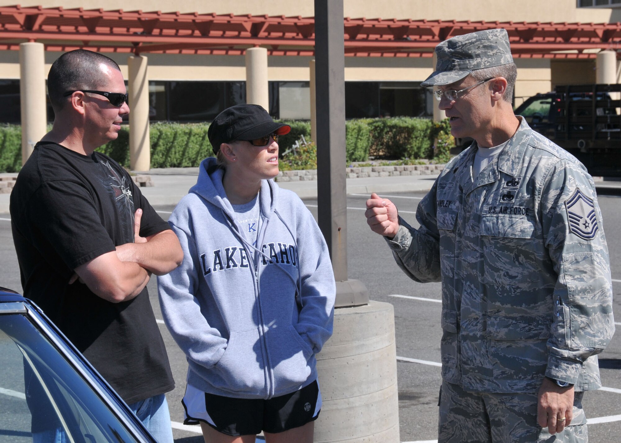 TRAVIS AIR FORCE BASE, Calif. -- Senior Master Sgt. James Standley, 349th Maintenance Group, speaks with Technical Sgt. Ariana Dahl, 349th Logistics Readiness Squadron, and her husband during the base block party held here on Sept. 24th. (U.S. Air Force photo/Master Sgt. Robert Wade)