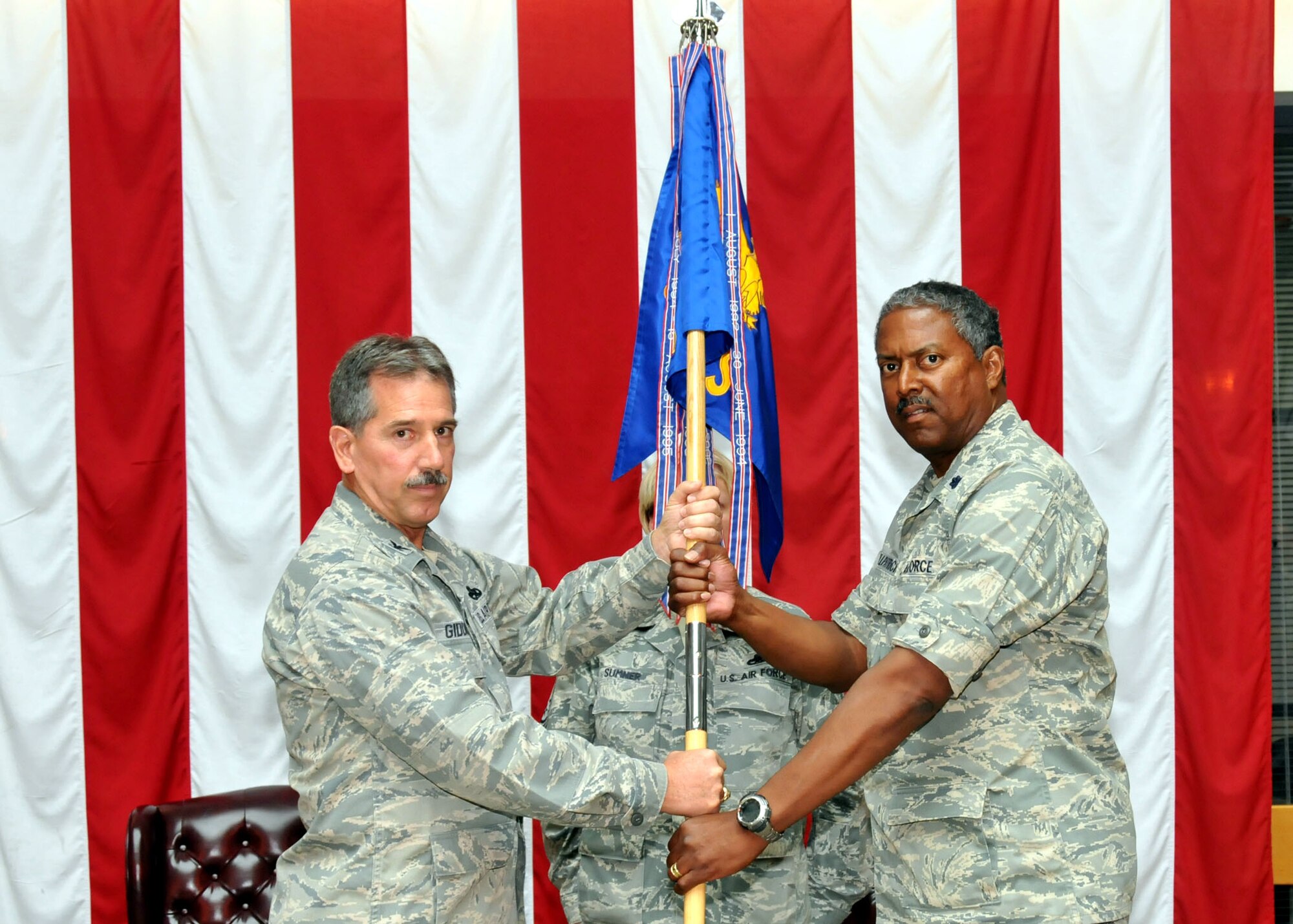 TRAVIS AIR FORCE BASE, Calif. -- Col. Melvin Giddings, Jr., 349th Maintenance Group commander, passes the 349th Maintenance Squadron guidon to Lt. Col. Lawrence Killpatrick. Killpatrick took command of the squadron in an assumption of command Sept. 25. (U.S. Air Force photo/Master Sgt. Robert Wade)