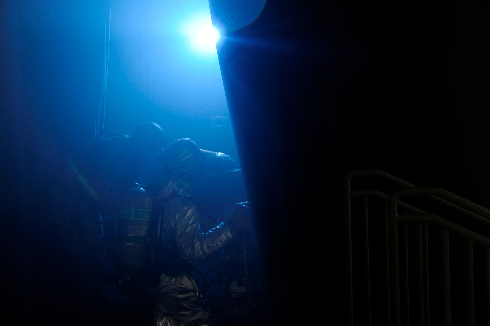 Firefighters from the 8th Civil Engineer Squadron clear out the base theater to check for causalities during a scenario in which the Exercise Evaluation Team said the base theater's curtains caught on fire at Kunsan Air Base, Republic of Korea, Oct. 24, 2011. The EET's scenarios included a full spectrum of events, keeping the wing fully engaged around the clock as maintainers launched aircraft, security forces defended the base and firefighters responded to a multitude of emergency situations. (U.S. Air Force photo by Staff Sgt. Rasheen Douglas/Released)