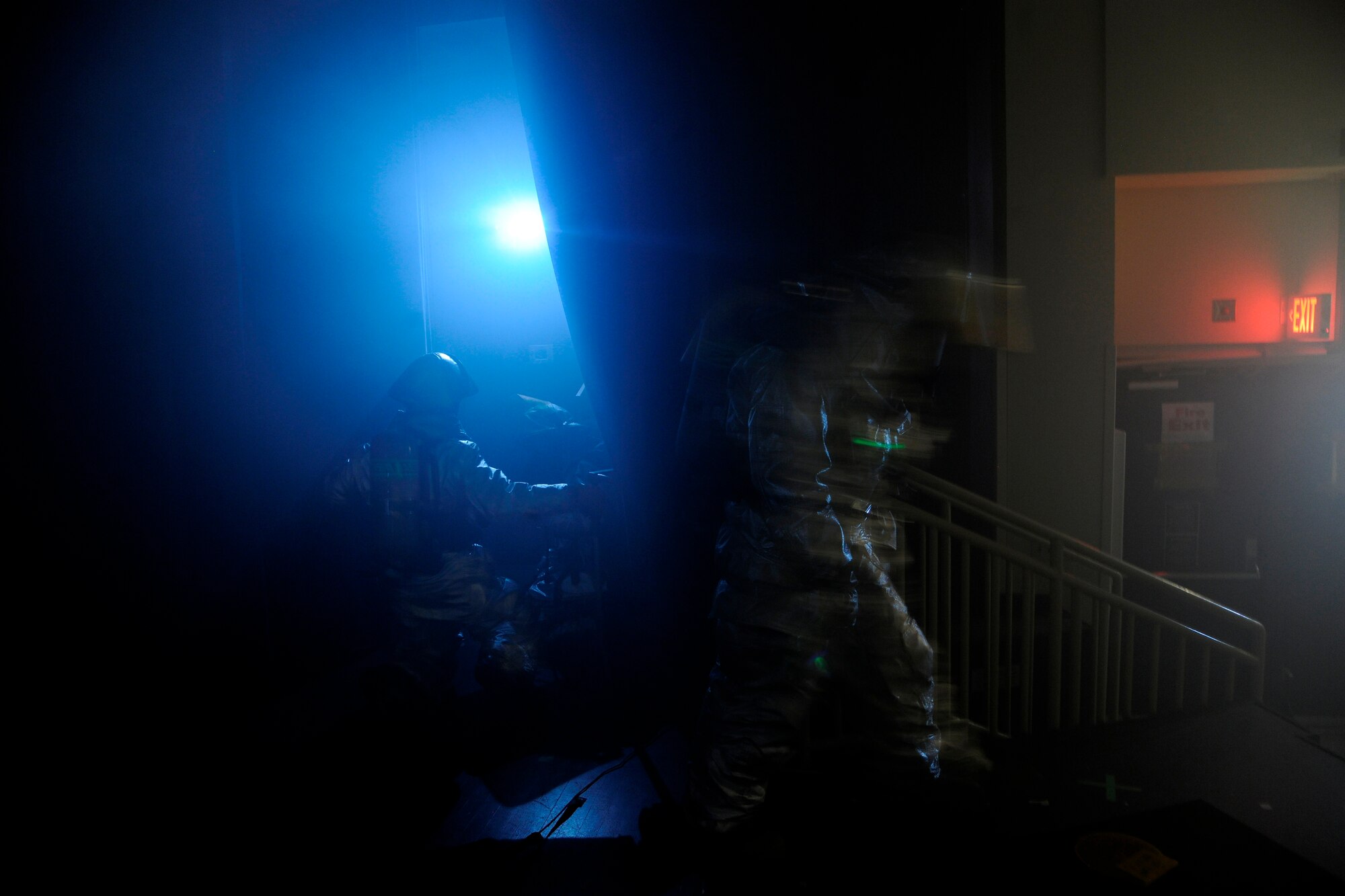 Firefighters from the 8th Civil Engineer Squadron clear out the base theater to check for causalities during a scenario in which the Exercise Evaluation Team said the base theater's curtains caught on fire at Kunsan Air Base, Republic of Korea, Oct. 24, 2011. The EET's scenarios included a full spectrum of events, keeping the wing fully engaged around the clock as maintainers launched aircraft, security forces defended the base and firefighters responded to a multitude of emergency situations. (U.S. Air Force photo by Staff Sgt. Rasheen Douglas/Released)