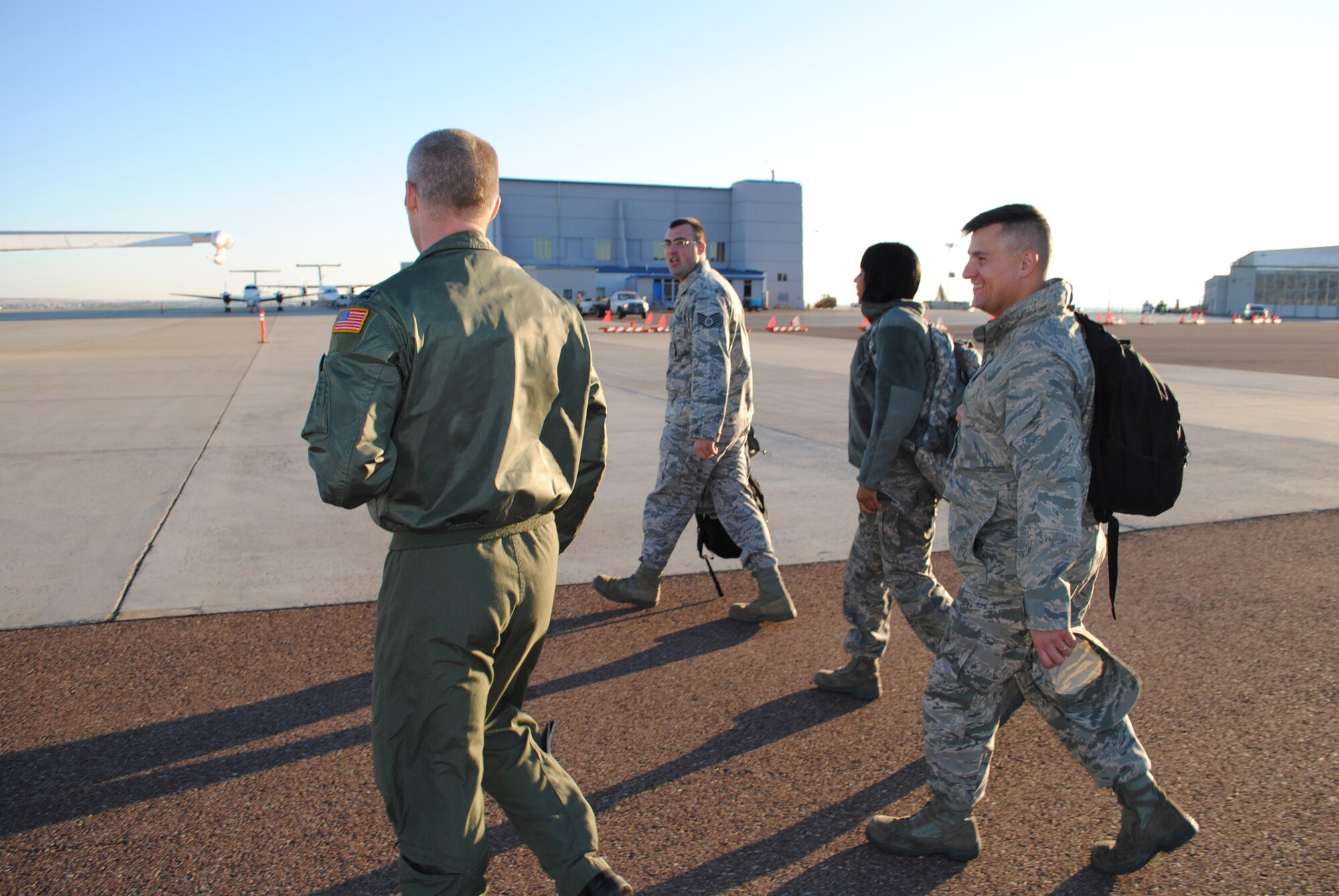 Capt. Bill Dyer, left, escorts incentive flight riders; Staff Sgt. Kyle Baker, 341st Missile Maintenance Squadron critical task supervisor; Senior Airman Anastasia Miller, 341st Operations Support Squadron/accounting apprentice; and Tech. Sgt. Scott Devore, 12th Missile Squadron facility manager; to the Navy E-6B mobile command post, or airborne platform. Dyer, from the 625th Strategic operations Squadron in Offut AFB, Nev., was a crew member on the flight Oct. 18. (U.S. Air Force photo/Airman Cortney Paxton)