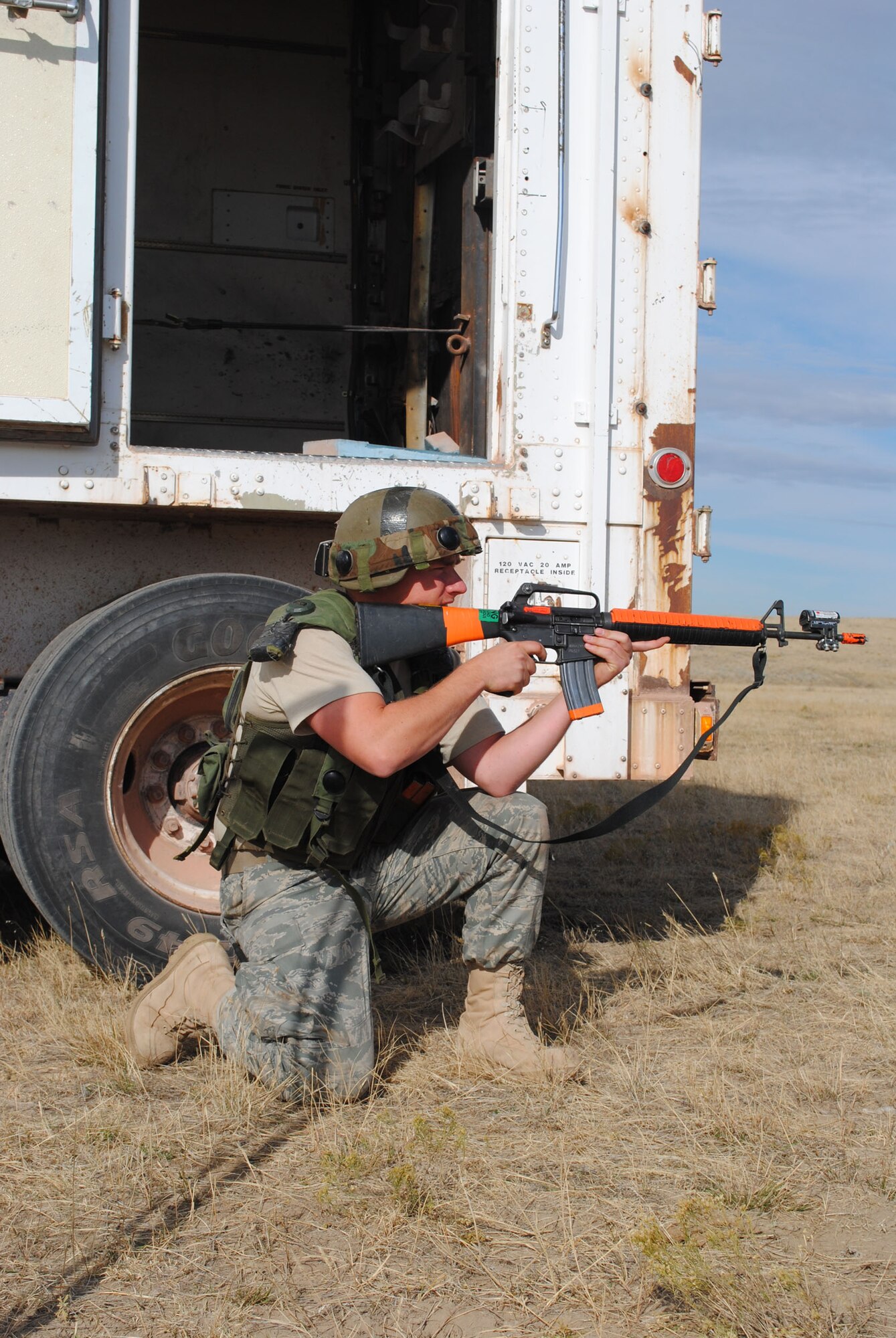Senior Airman Cory Carlson, missile maintenance technician with the 341st Missile Maintenance Squadron, secures the resource, conducts maintenance on the PT van and follows orders by running for cover during the Road Warrior IX course. (U.S. Air Force photo/Airman 1st Class Katrina Heikkinen)