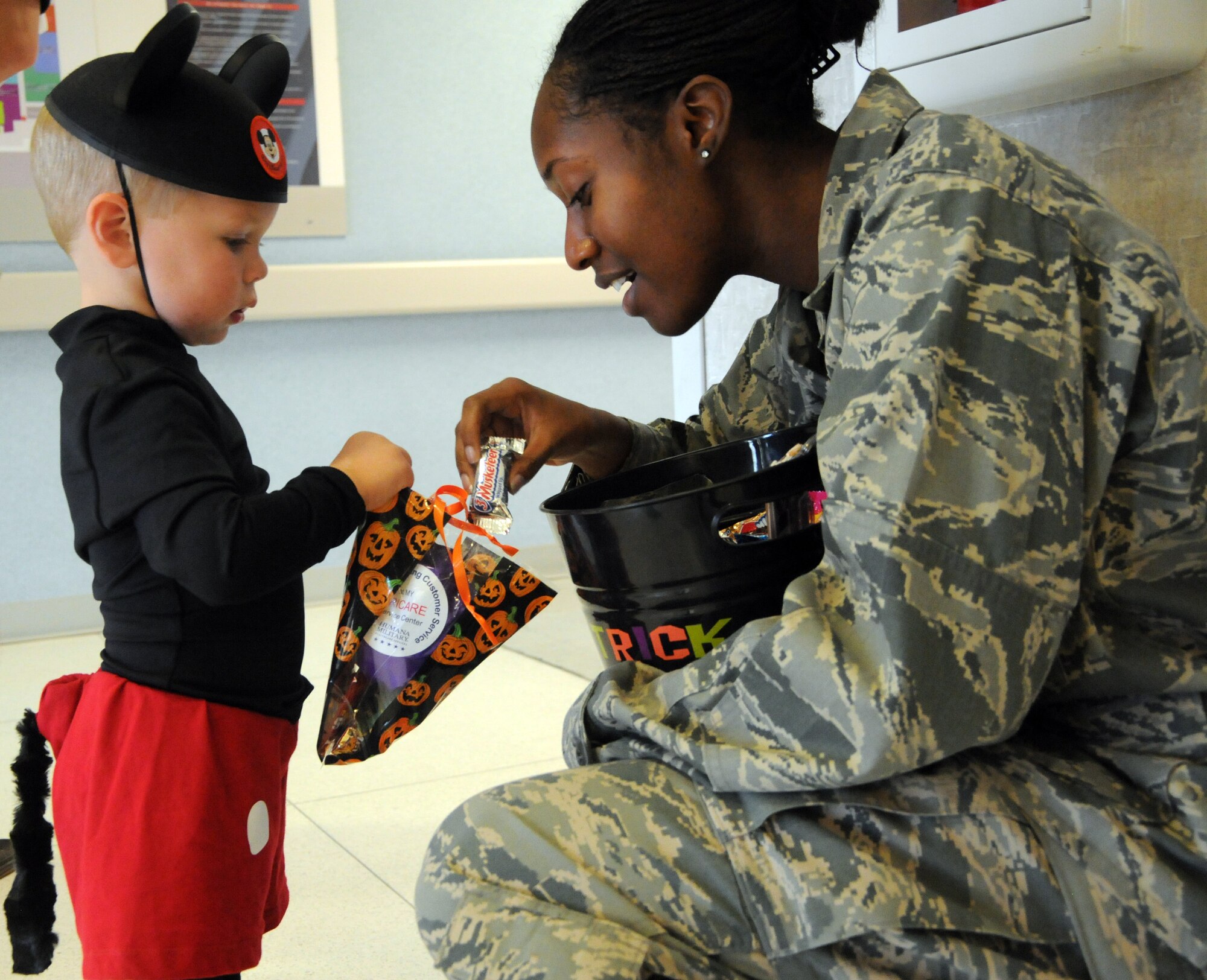 LAUGHLIN AIR FORCE BASE, TEXAS — A Laughlin child receives candy from an Airman in the 47th Medical Group building. The Family Child Care Center put on the event to give children an opportunity to show off their costumes and receive candy early. (U.S. Air Force photo/2nd Lt. James Ramirez)