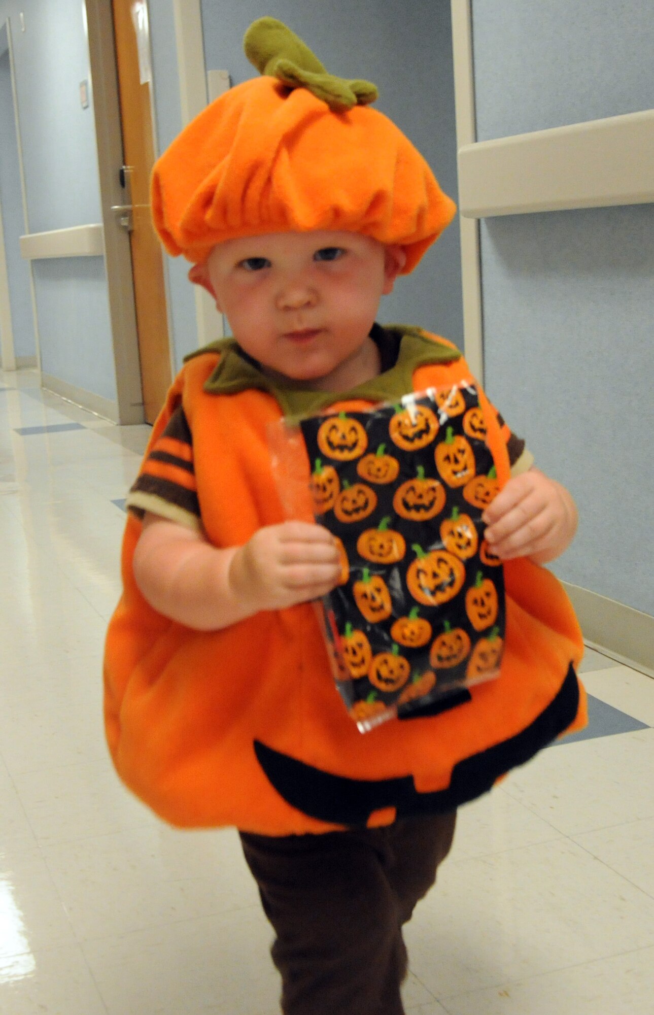 LAUGHLIN AIR FORCE BASE, TEXAS—A child from Laughlin carries his candy from one office to the next in the 47th Medical Group building. The Family Child Care Center put on the event to give children an opportunity to show off their costumes and receive candy early. (U.S. Air Force photo/2nd Lt. James Ramirez)