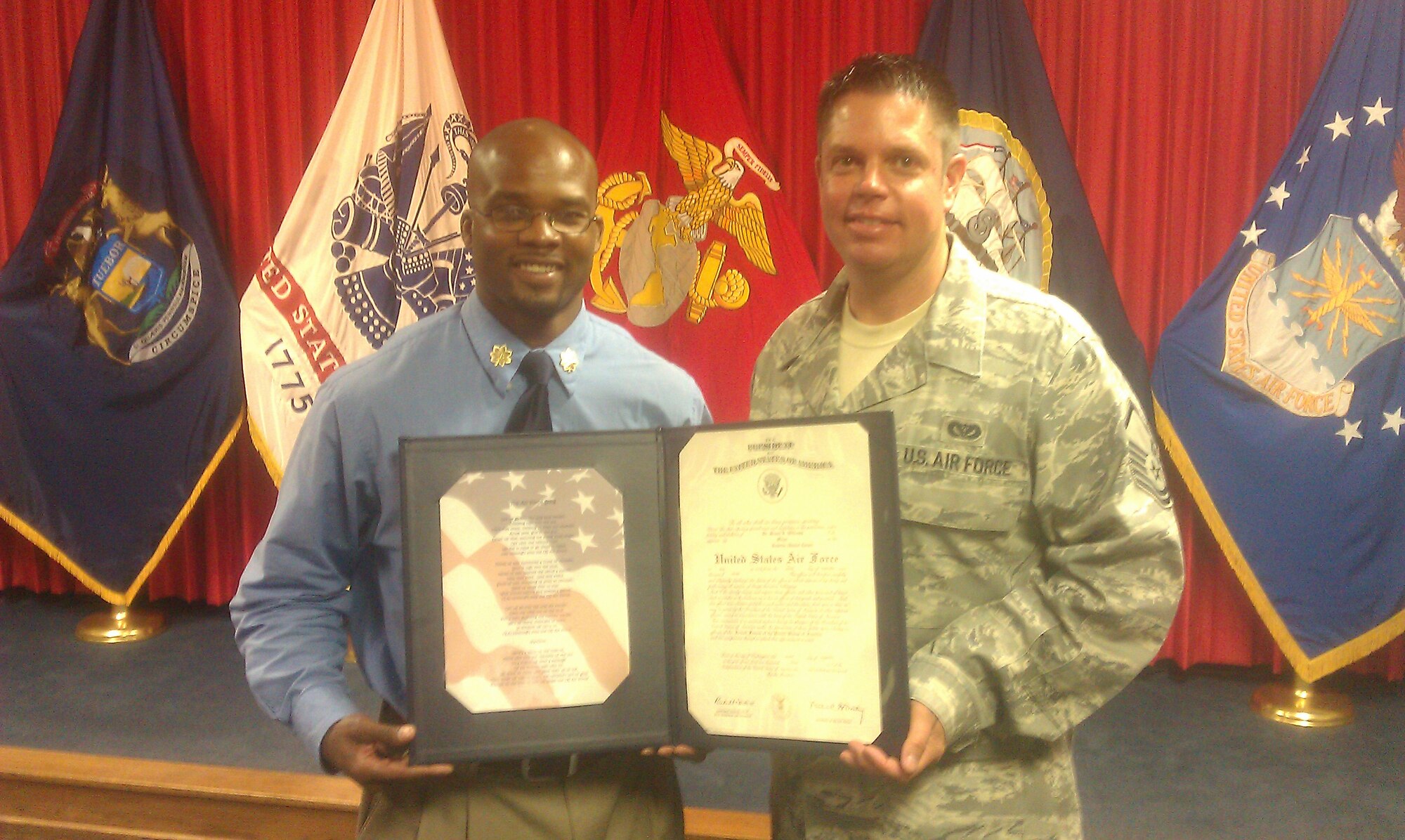 Maj. Bryan Williams, maxillofacial prosthodontist (left), traded his private dental career for the opportunity to serve his country. Master Sgt. Kevin Harvey, Military Entrance Processing station senior liaison supervisor (right), recruited Williams and was also present at his commissioning. (U.S. Air Force photo/Master Sgt. Dan Cady)