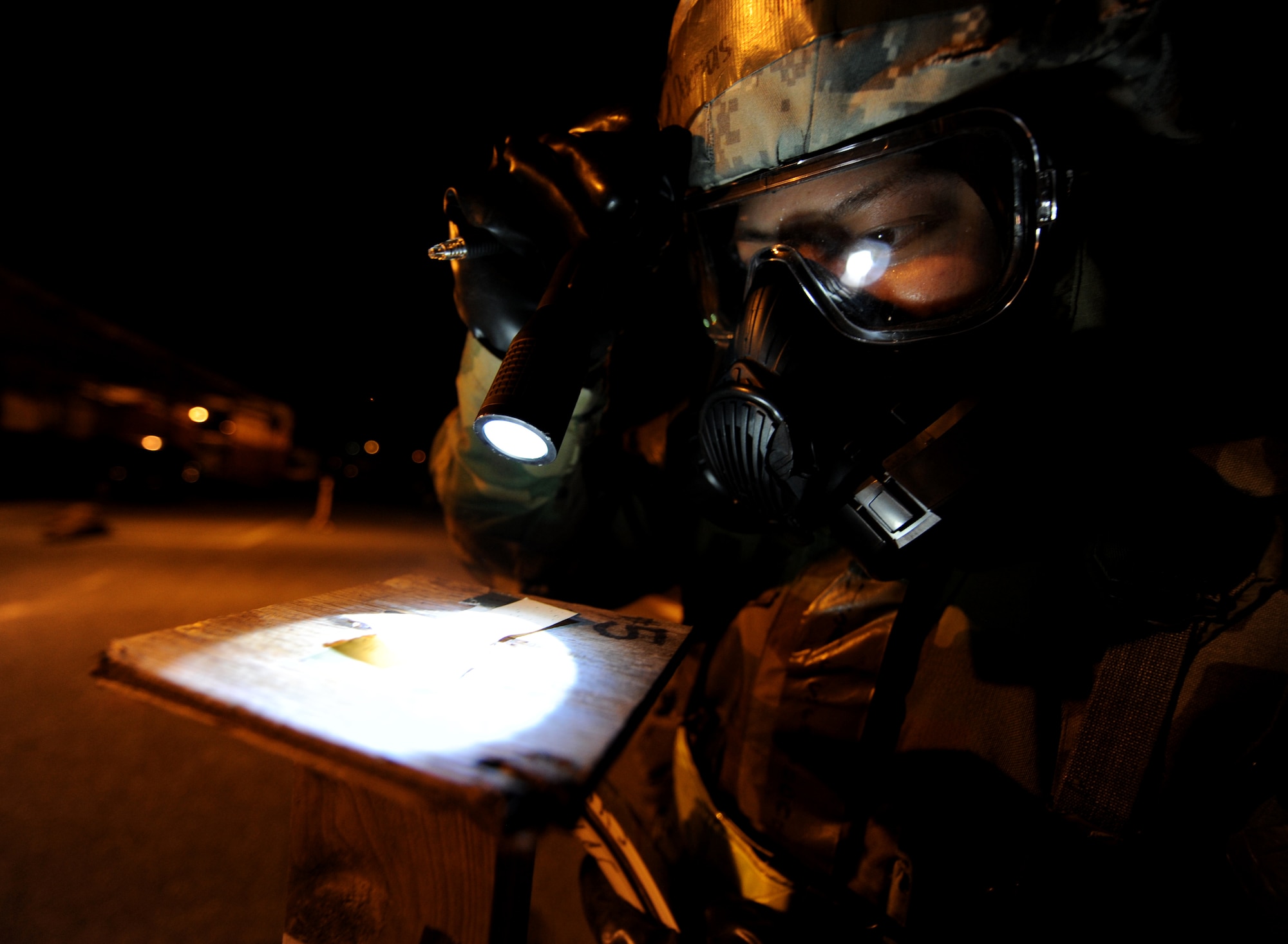 U.S. Air Force Senior Airman Christopher Duenas, 18th Logistics Readiness Squadron vehicle operator, inspects the M-8 chemical detection paper while conducting a post attack reconnaissance sweep during Beverly High 12-1, a local operational readiness exercise, on Kadena Air Base, Japan, Oct. 27. During the week-long phase one and two exercise, Airmen across the base train in a variety of training scenarios to include self-aid and buddy care and chemical attacks. (U.S. Air Force photo/Airman 1st Class Jarvie Z. Wallace/released) 
