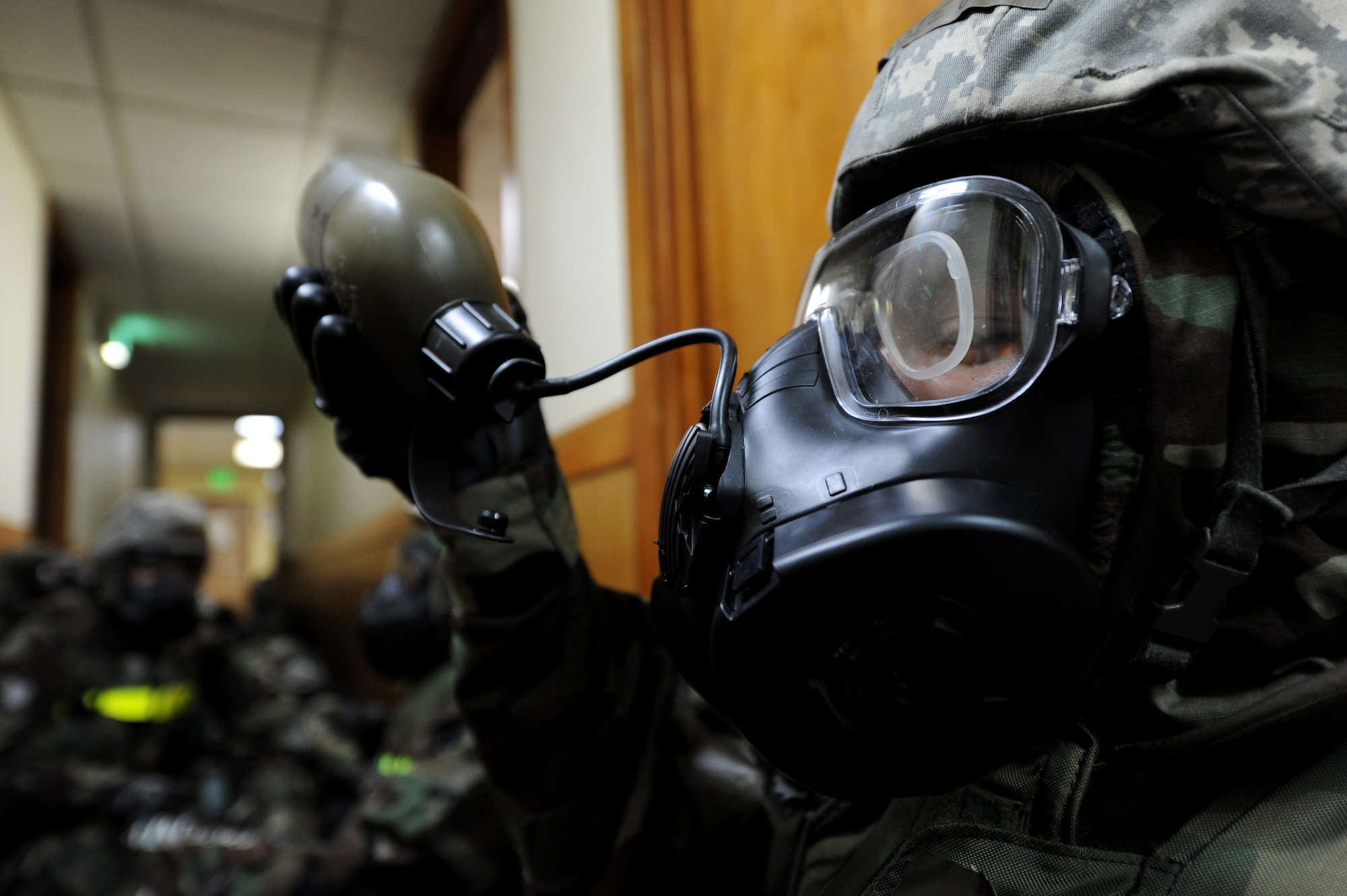 U.S. Air Force Airman 1st Class Jessie Ornelas, 18th Logistics Readiness Squadron vehicle operator, drinks from his canteen to stay hydrated while in his mission-oriented protective posture gear during Beverly High 12-1, a local operational readiness exercise, on Kadena Air Base, Japan, Oct. 27. During the LORE, Airmen are expected to perform and operate in numerous scenarios from minor on-the-job injuries, to bomb threats, chemical and aerial attacks. (U.S. Air Force photo/ Airman 1st Class Jarvie Z. Wallace/released)
