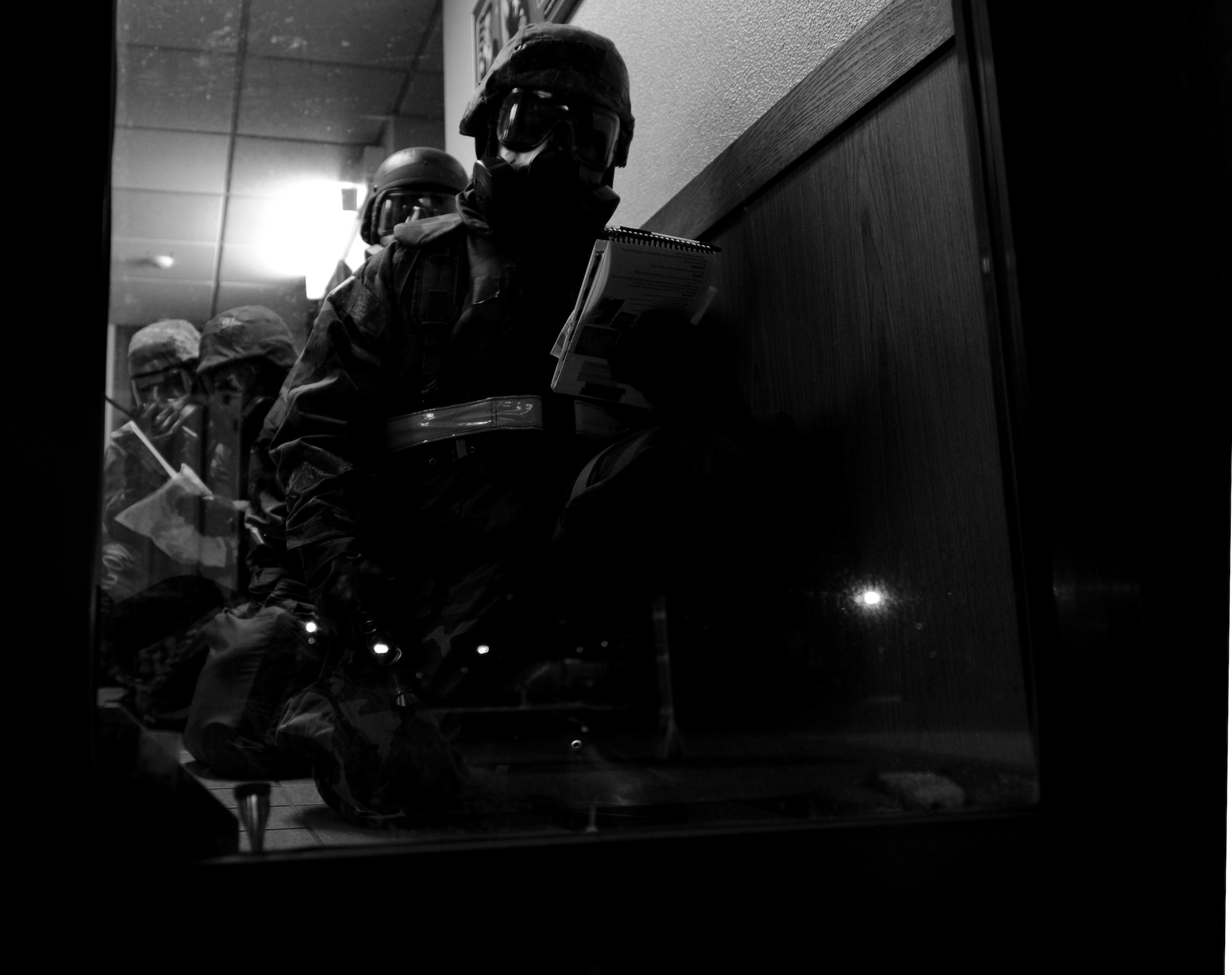 U.S. Air Force Senior Airman Christopher Duenas, 18th Logistics Readiness Squadron vehicle operator, refers to his Airman's Manual prior to conducting a post attack reconnaissance sweep during Beverly High 12-1, a local operational readiness exercise, on Kadena Air Base, Japan, Oct. 27. During the week-long phase one and two exercise, Airmen across the base train in a variety of training scenarios to include self-aid and buddy care and chemical attacks. (U.S. Air Force photo/Airman 1st Class Jarvie Z. Wallace/released)
