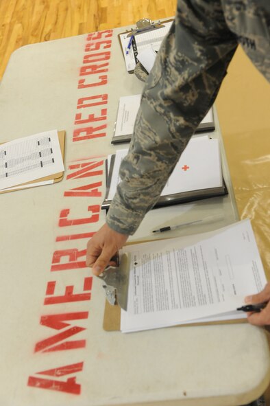An Airman retrieves paperwork during a blood drive at the Freedom I Fitness Center, Moody Air Force Base, Ga., Oct. 26, 2011. Once donated blood is properly tested and stored, it becomes available for shipment to hospitals 24 hours a day, 7 days a week. (U.S. Air Force photo by Airman 1st Class Paul Francis/Released)
