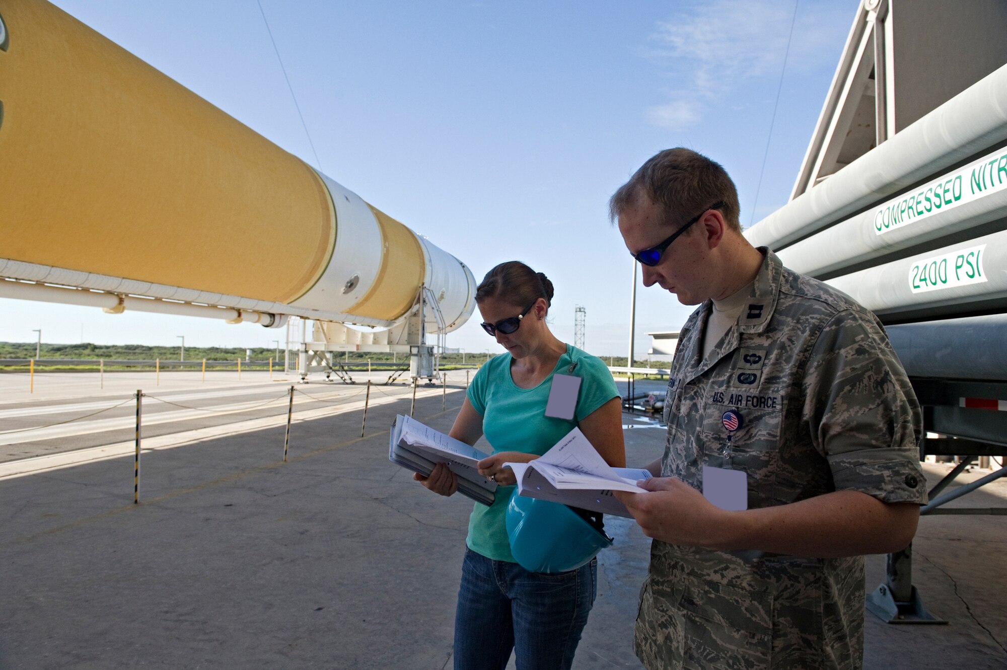 CAPE CANAVERAL AIR FORCE STATION, Fla. -- Jennifer Nathman Fraenzl, lead engineer, and Capt. Daniel Wilkenson, both of the 5th Space Launch Squadron's Delta Flight, oversee preparations for erecting a United Launch Alliance Delta IV booster on Pad 37. The Launch Vehicle on Stand process took place Oct. 11, 2011. The rocket is being prepared for the launch of Wideband Global Satcom-4 scheduled Jan. 19, 2012. (U.S. Air Force photo/Julie Dayringer)