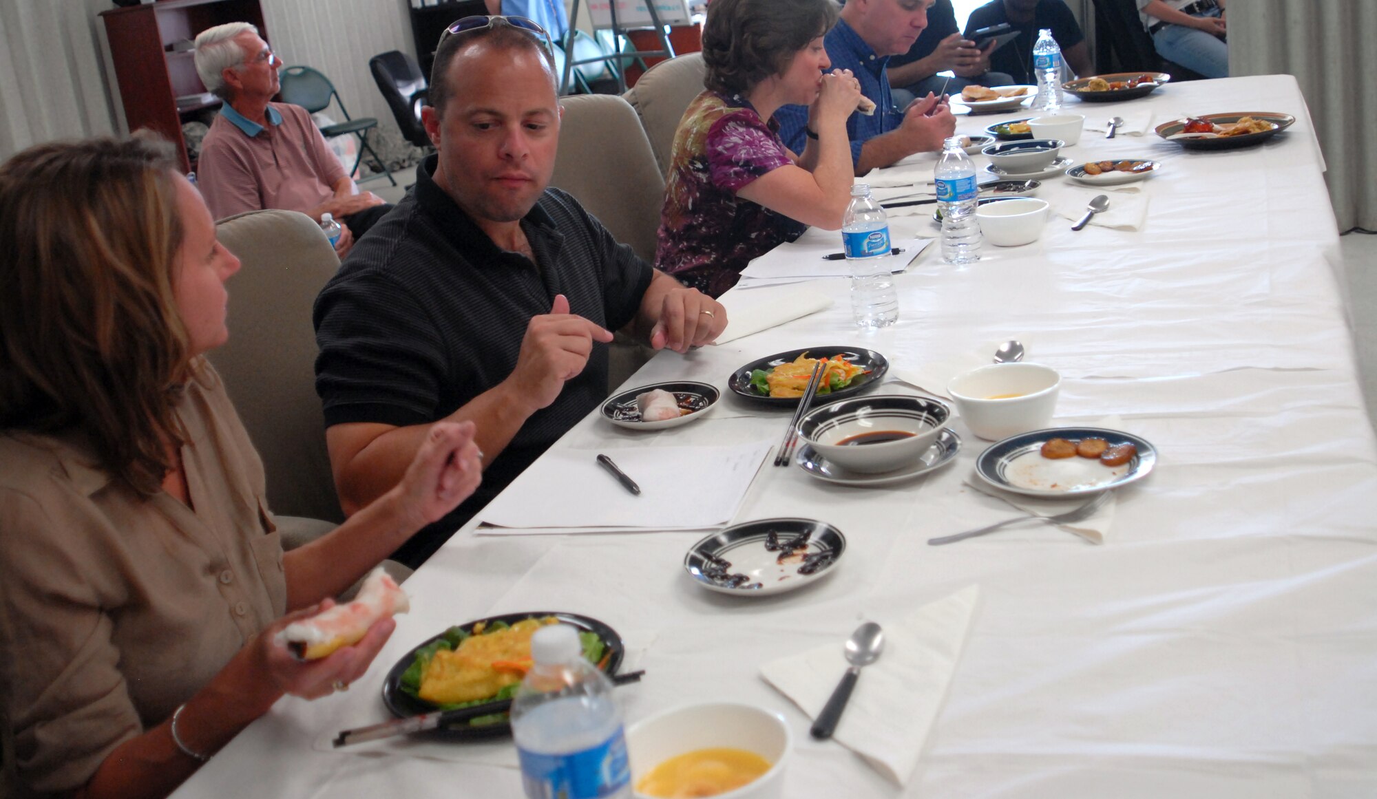 GOODFELLOW AIR FORCE BASE, Texas-- Col. Mark Damiano, 17th Training Wing Commander, his wife Ellery, Chaplain (Lt. Col.) Bruce Glover and his wife, Carol judge the dishes team 341 present during the final round of the ‘Iron Chef’ competition at Crossroads here Oct. 22. The three-person team earned first place with their Asian style dishes, each containing the secret ingredient, plantains. (U.S. Air Force photo/Airman 1st Class Jessica Keith) 