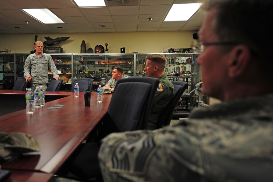 Senior Airman Joshua Lail, 4th Civil Engineer Squadron Explosive Ordnance Disposal flight technician, describes his recent deployment to Col. Patrick Doherty, 4th Fighter Wing commander, and Chief Master Sgt. Blake Malpass, 4 FW command chief, at Seymour Johnson Air Force Base, N.C., Oct. 25, 2011. The commander and chief traveled to various organizations on base to gain insight on the jobs Airmen are performing within the wing. Lail is a native of Hickory, N.C., Doherty is from Lincoln, Neb., and Malpass calls Greensboro, N.C., home. (U.S. Air Force photo by Senior Airman Rae Perry)