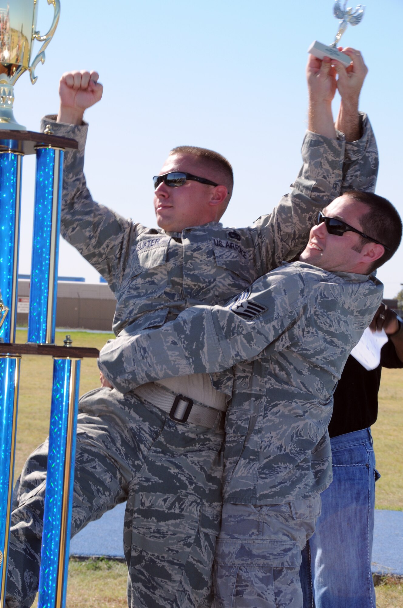 U.S. Air Force guardsmen assigned to the 137th Maintenance Squadron celebrate a commanding victory in the 3 legged race held on base, Oct 1. "This was one of the proudest moments of my career, said Staff Sgt Chris Howard. "I would like to thank my partner Tech Sgt Slater for his continued support throughout the race."
(U.S. Air Force Photo by Staff Sgt Caroline Hayworth/Released)
