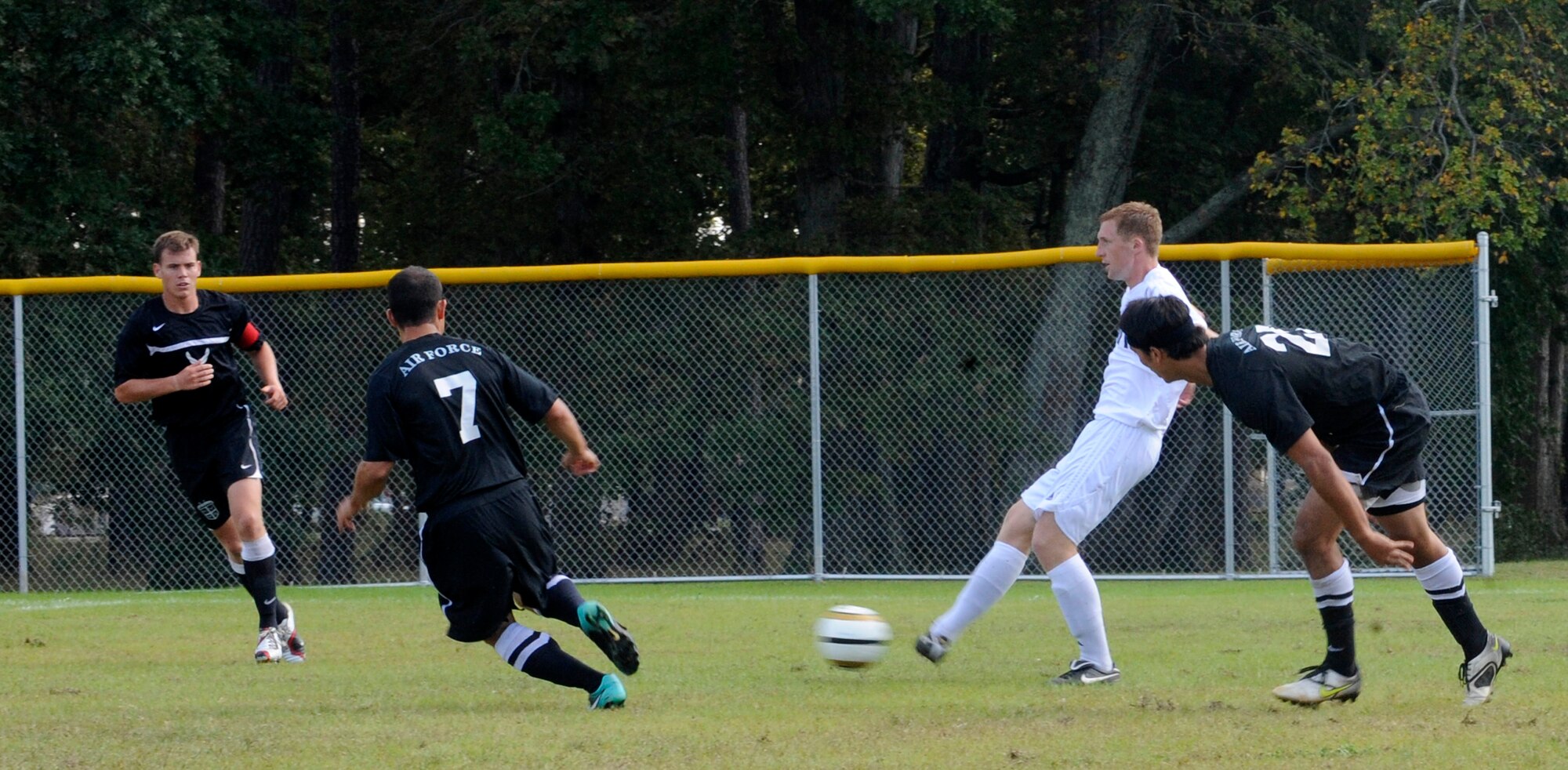 Members of the All-Air Force and Navy Men’s Soccer Teams fight it out during the Armed Forces Soccer Championship Tournament game at Fort Eustis Monday.  The tournament gave the teams a chance to showcase their talents while competing against other services. The Air Force won the championship, defeating the Navy 1-0. (U.S.Air Force photo by Staff Sgt. Dana Hill/RELEASED)
