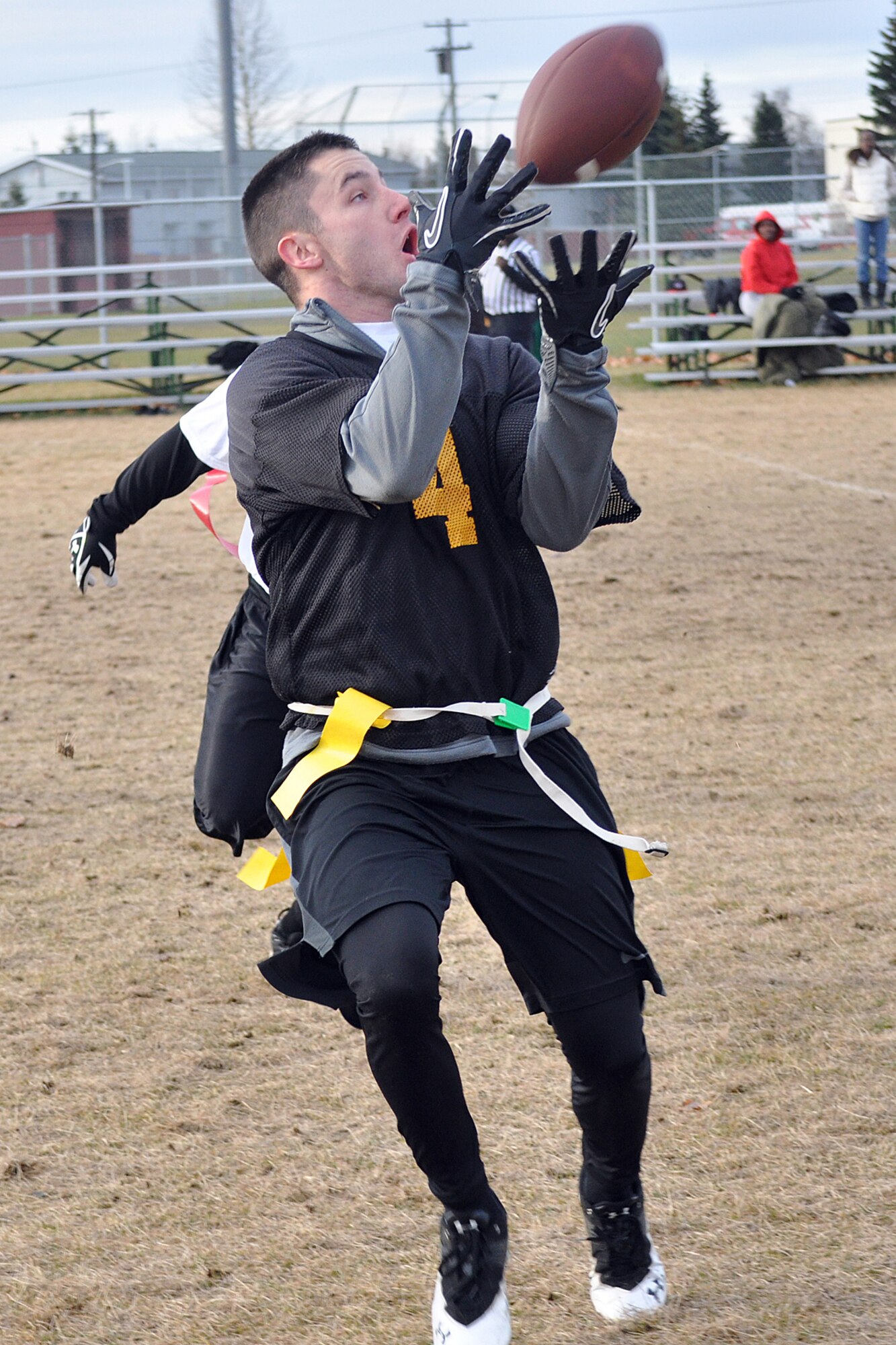 Chuck Berry catches a pass for the 95th Chemical Company against the 673d Force Support Squadron in the first game of the Joint Base Elmendorf-Richardson flag football tournament Saturday at the Buckner Physical Fitness Center field. Berry and the 95th beat FSS 18-13 to advance in the tournament. (U.S. Air Force photo/John Pennell)