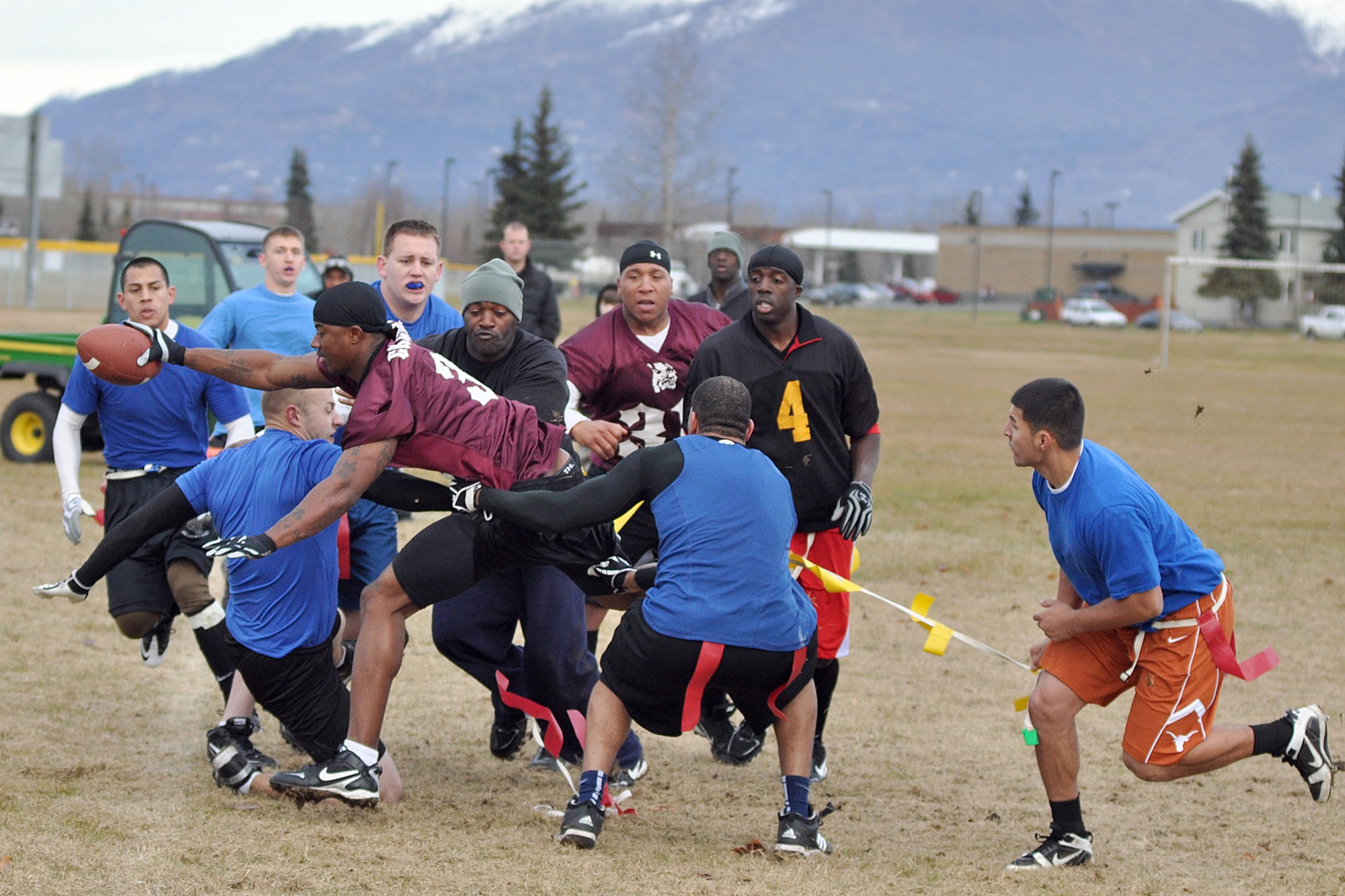 Richard Pantoja (orange shorts) saves a cricical touchdown by grabbing Xavier Chance?s flag before he can cross the goal line on a 4th and goal carry in the final minutes of the championship game. Pantoja and his 3rd Equipment Maintenance Squadron teammates defeated Chance and the 56th Engineers 13-8 to claim the Joint Base Elmendorf-Richardson flag football title. (U.S. Air Force photo/John Pennell)