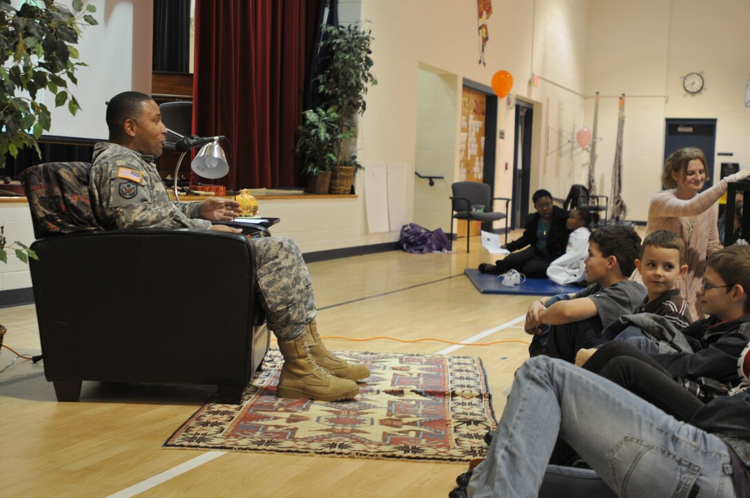 Family members take part in the Military Child Education Coalition's Tell Me A Story event Oct. 20 at General Stanford Elementary School at Fort Eustis to hear the reading of The Incredible Farkle McBride, written by John Lithgow, and read to the audience by Col. Brent Penny of Training and Doctrine Command. (U.S. Army photo by Pfc. Alex Kilmon/RELEASED)
